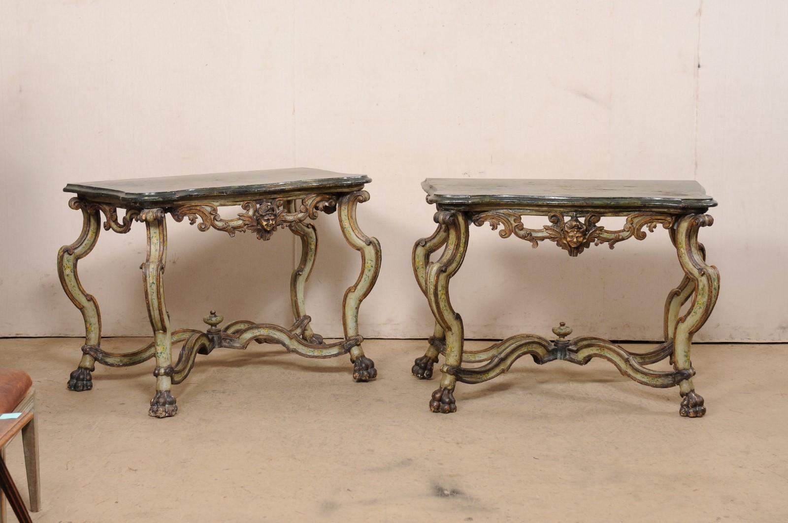 An Italian Venetian pair of ornately carved and painted wood console tables from the 18th century. This antique pair of Venetian tables from Italy have been designed with elaborate and curvaceous details. Each featuring tops with serpentine shaped