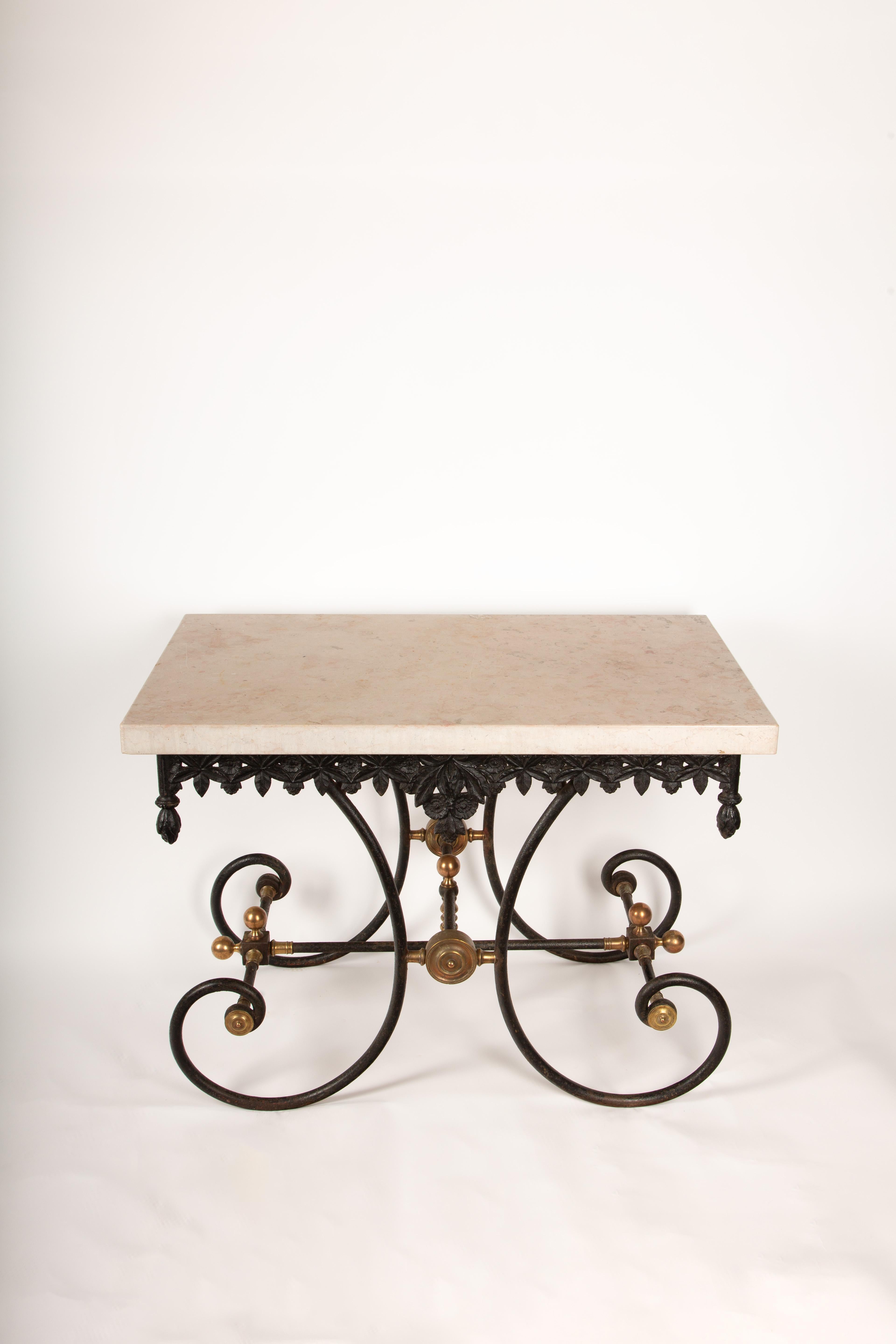 This exceptional pair of 19th-century French baker’s tables is a rare find, offering a blend of historical craftsmanship and modern refinement. The bases, crafted from intricately detailed cast iron, showcase the period’s characteristic ornate