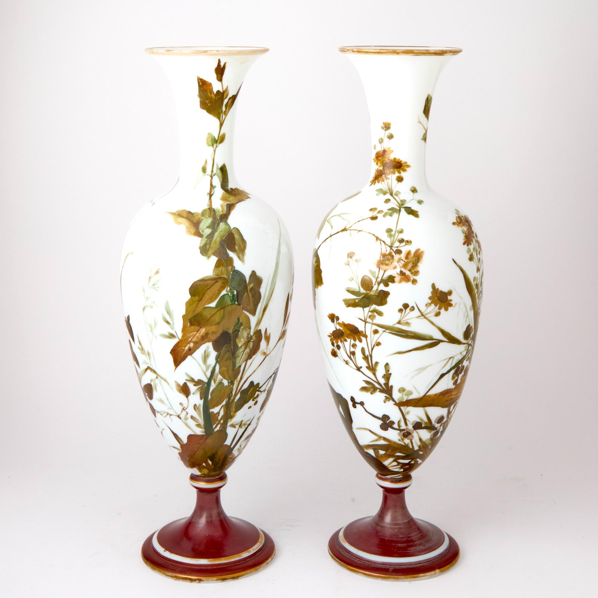 A rare and remarkable pair of antique French opaline glass vases, dating from the early to mid-19th century, showcasing the height of French decorative arts and craftsmanship. These striking pieces are masterfully formed in a graceful bottle-shaped