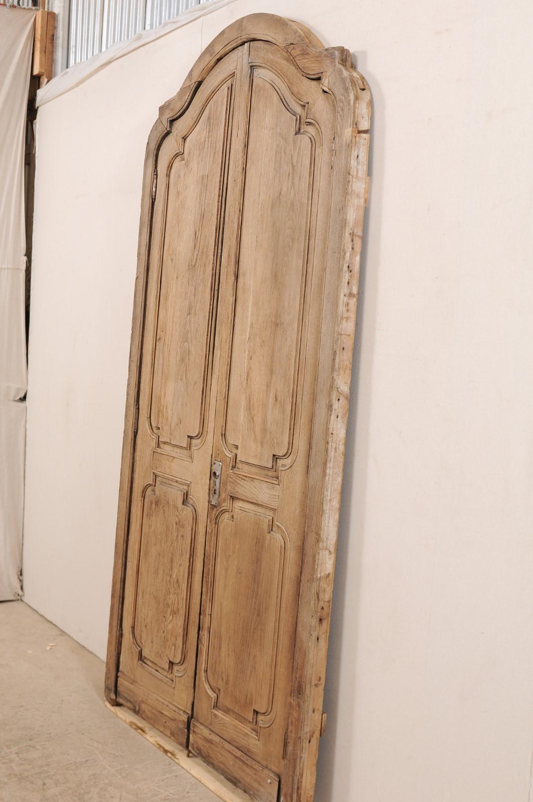 Exquisite Pair of Arched 19th Century Spanish Carved Wood Doors with Casing In Good Condition In Atlanta, GA