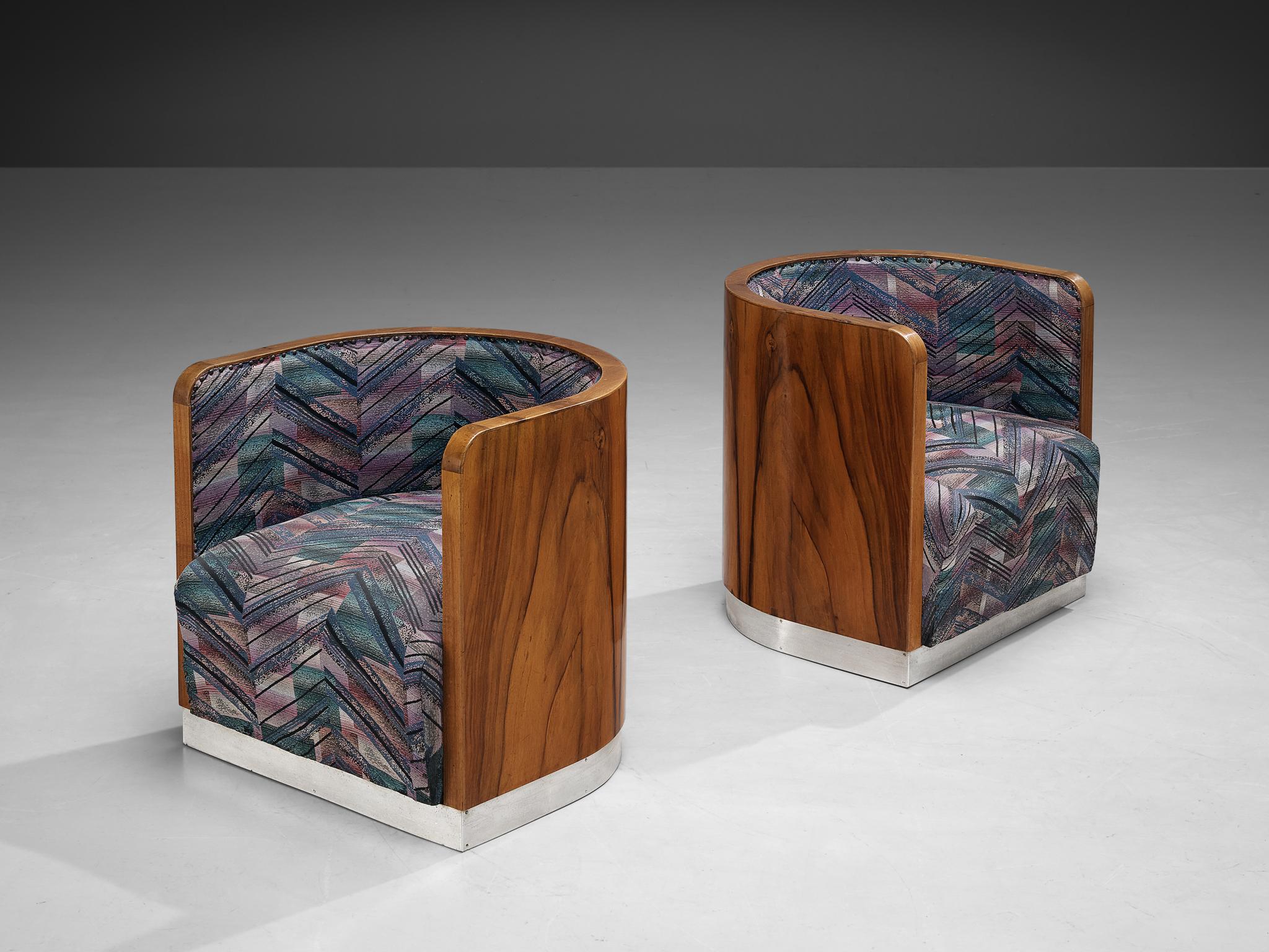 Pair of club chairs, walnut, metal, fabric, Italy, 1970s

The construction of these wonderful barrel chairs shows strong resemblance to the features of the Art Deco design language. The corpus is executed in walnut exhibiting a beautiful round