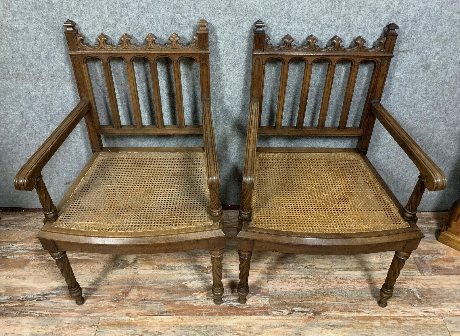 Elevate your interior decor with this exquisite pair of Gothic walnut armchairs, crafted around 1850. Inspired by the architectural elements of the medieval period, these stunning armchairs showcase timeless craftsmanship and intricate