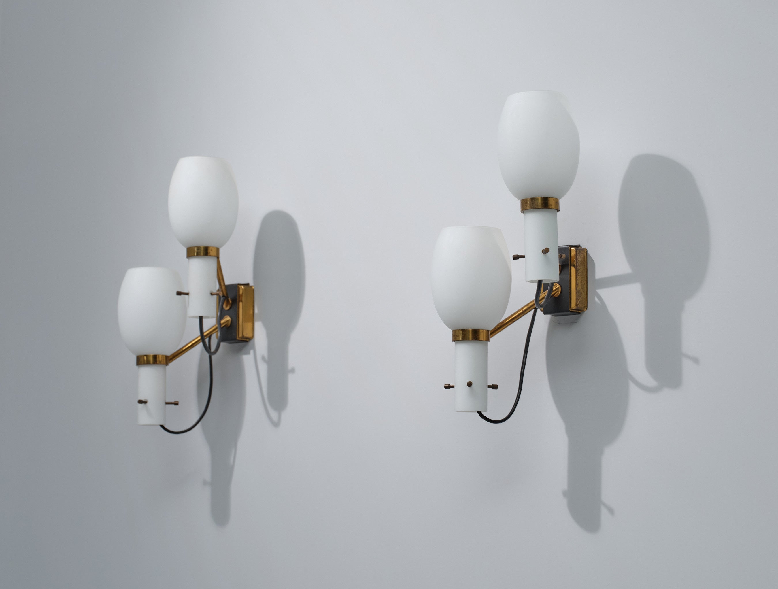 Introducing a Pair of Mid-Century Modern Italian Wall Sconces, each featuring two distinct light sources and exquisite craftsmanship. Elevate the ambiance of your space with these stunning wall sconces, meticulously designed to exude elegance and