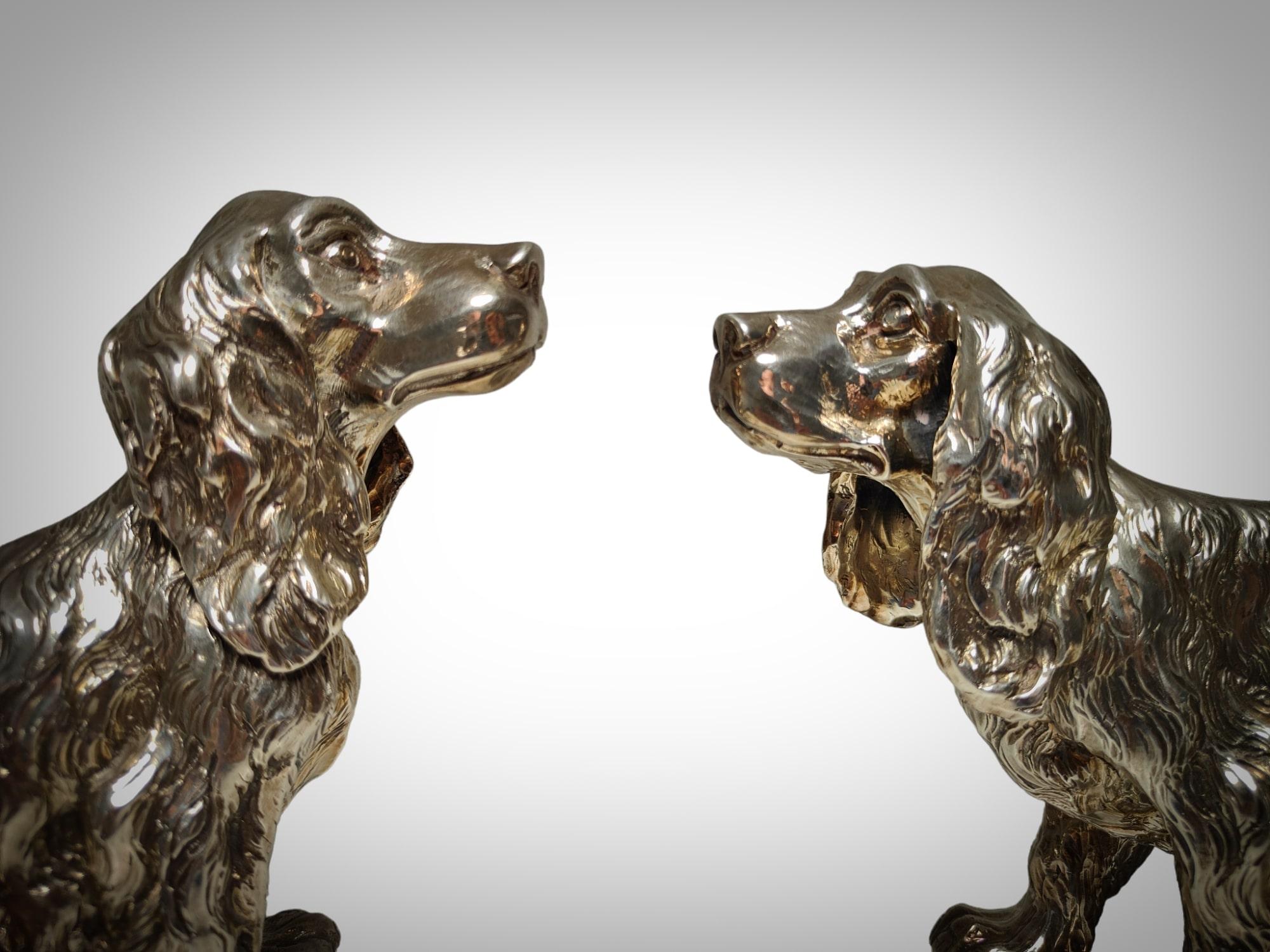 This elegant pair of Cocker Spaniel dogs is a true gem of solid silver craftsmanship. Each of these charming canines has been meticulously carved from authentic 925 sterling silver, showcasing the expertise of 20th-century Italian design. The level