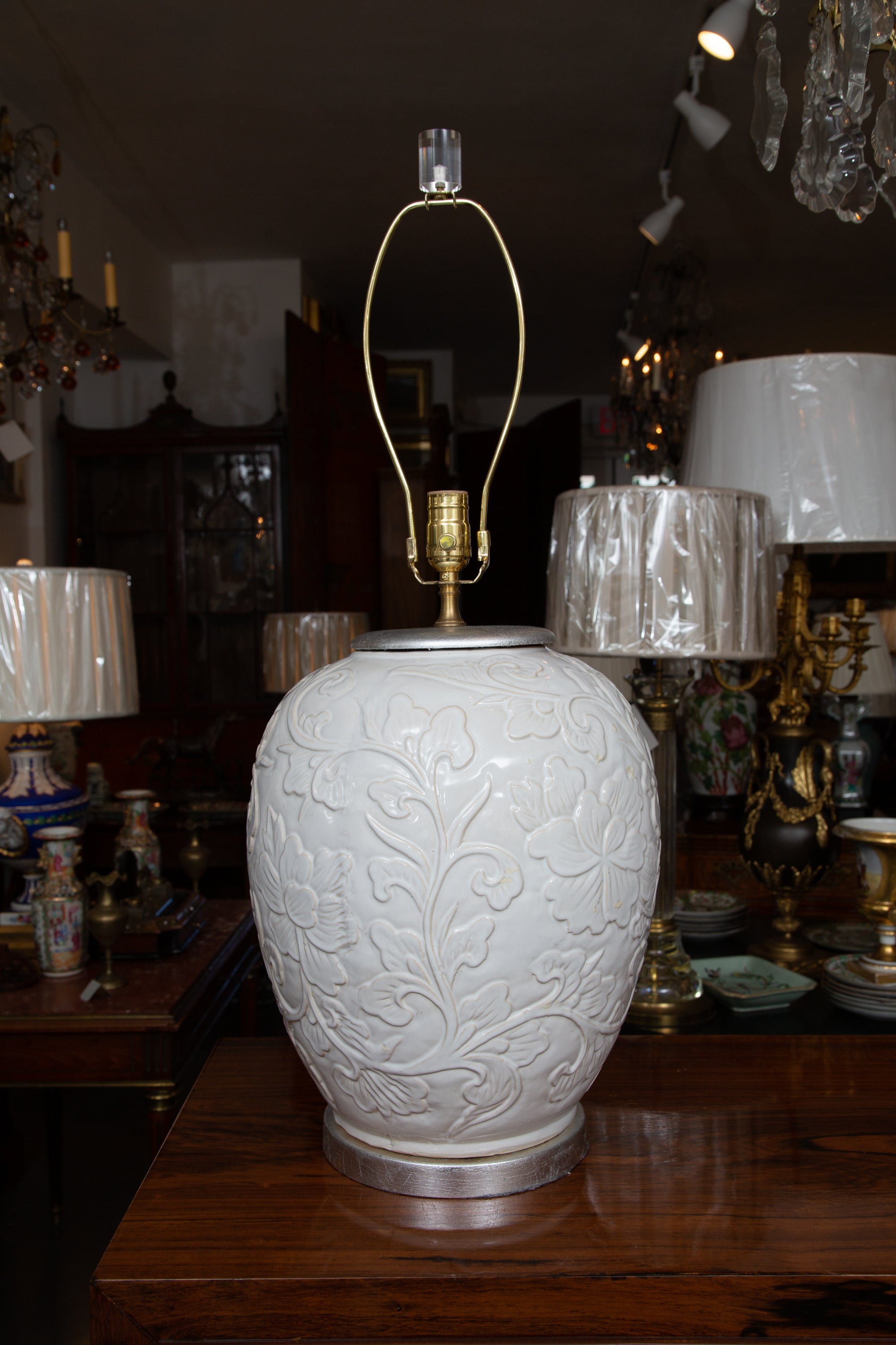 Fine pair of Italian handmade lamps with a raised relief design. Silver accents.