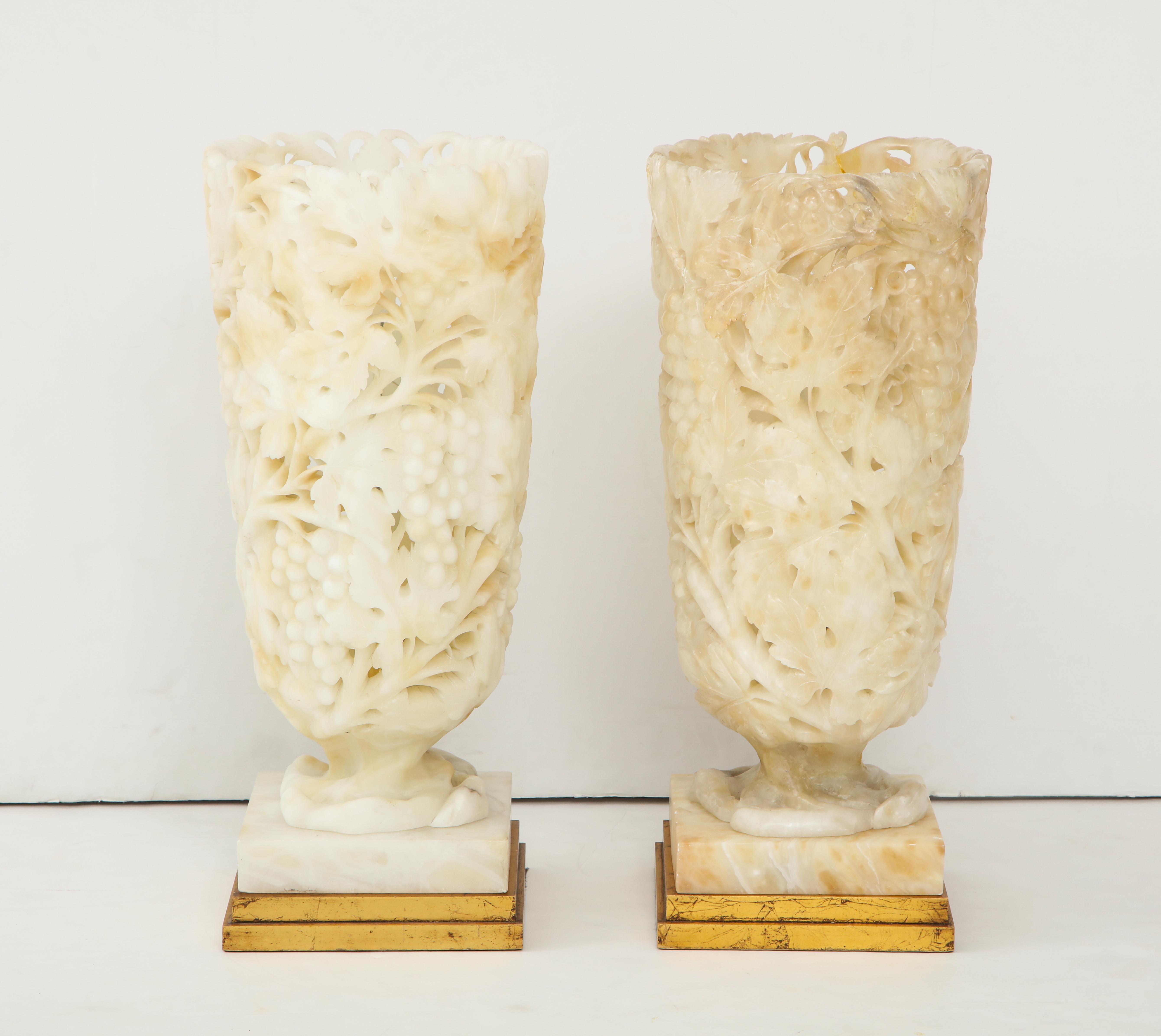 Spectacular pair of carved Alabaster lamps, they are carved with a pierced vine motif.
When illuminated the translucent Alabaster has a wonderful warm glow.
One lamps has been repaired in the past as illustrated in the last image.