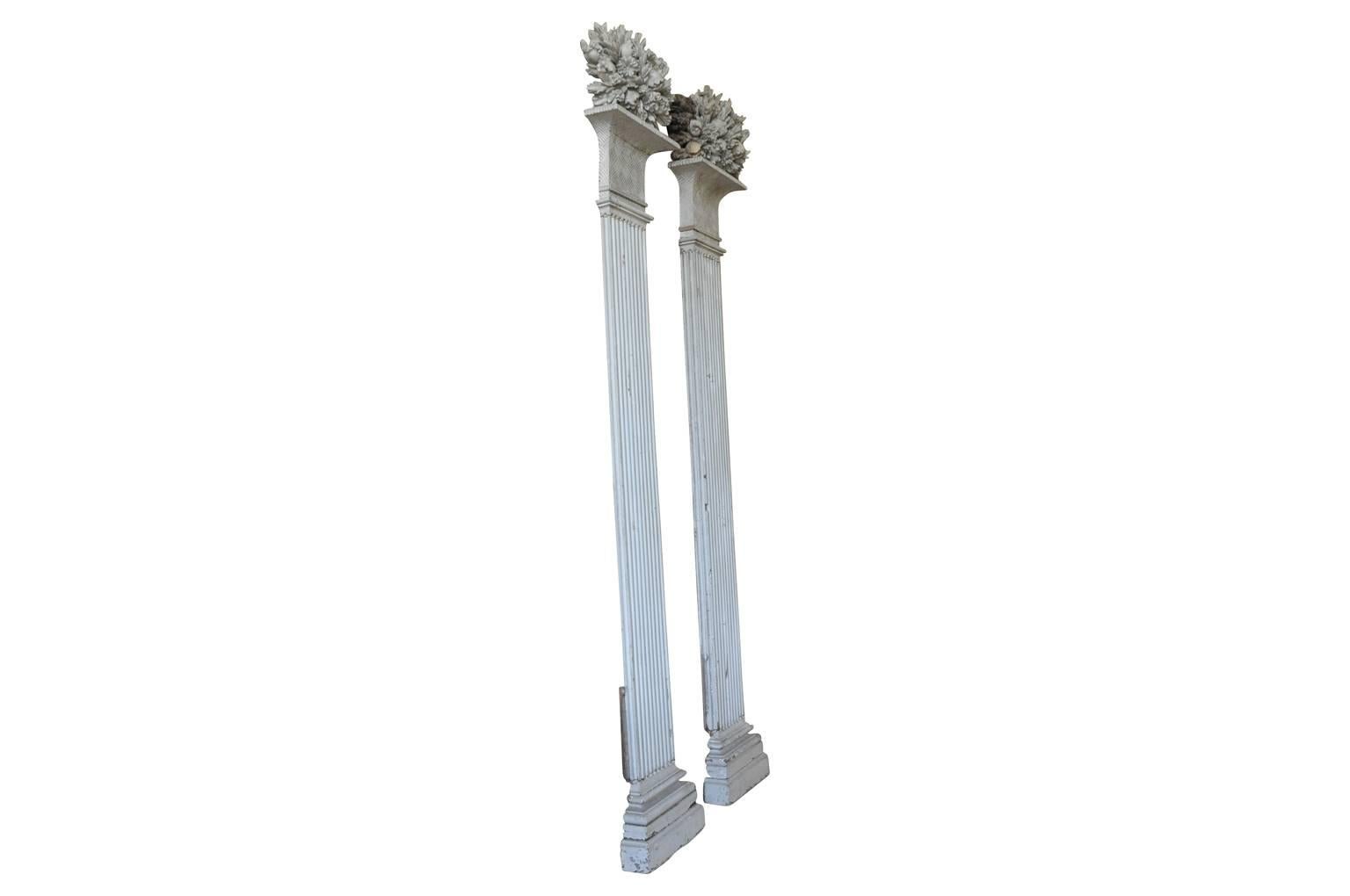 An outstanding and exceptional pair of Louis XVI period pilasters, columns from a private chateau in the Southwest of France. Wonderfully constructed from painted walnut and hand carved. Fluted columns/pilasters rest on plinths and topped with