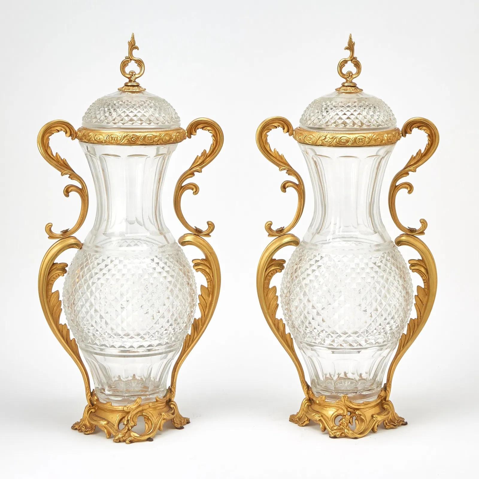 Exquisite Pair of Ormolu Mounted Crystal Scroll Form Handled Vases With Covers Attributed to Baccarat 

Date: Early 20th century 

Dimensions: Height 26 inches, depth 9 inches, width 12 inches