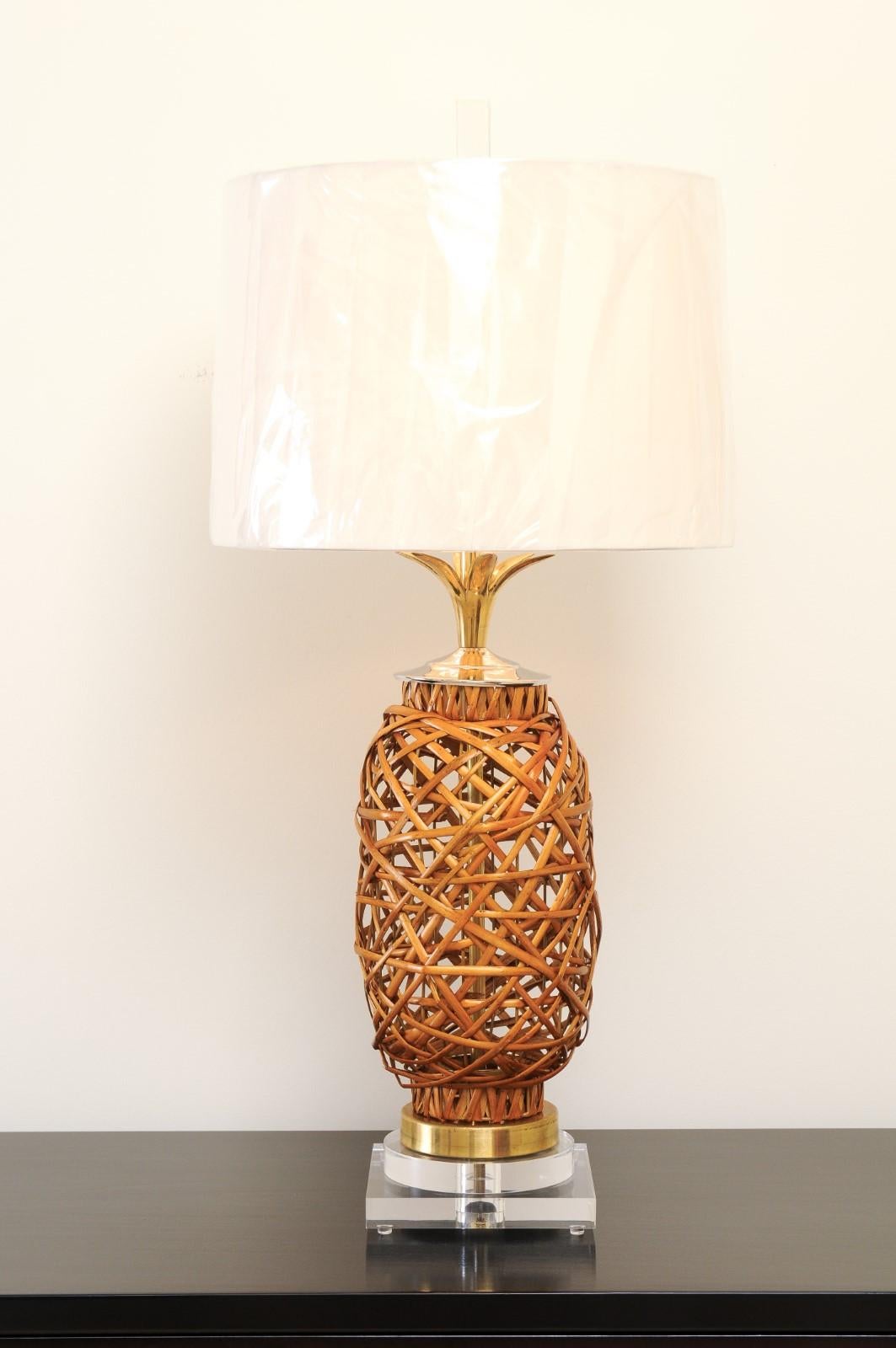 A stunning pair of restored rattan vessels, circa 1970, as newly built custom lamps. Lovely rattan form with accents in Lucite, brass and polished nickel. Exceptional craftsmanship and material selection. Functional dramatic jewelry that is both