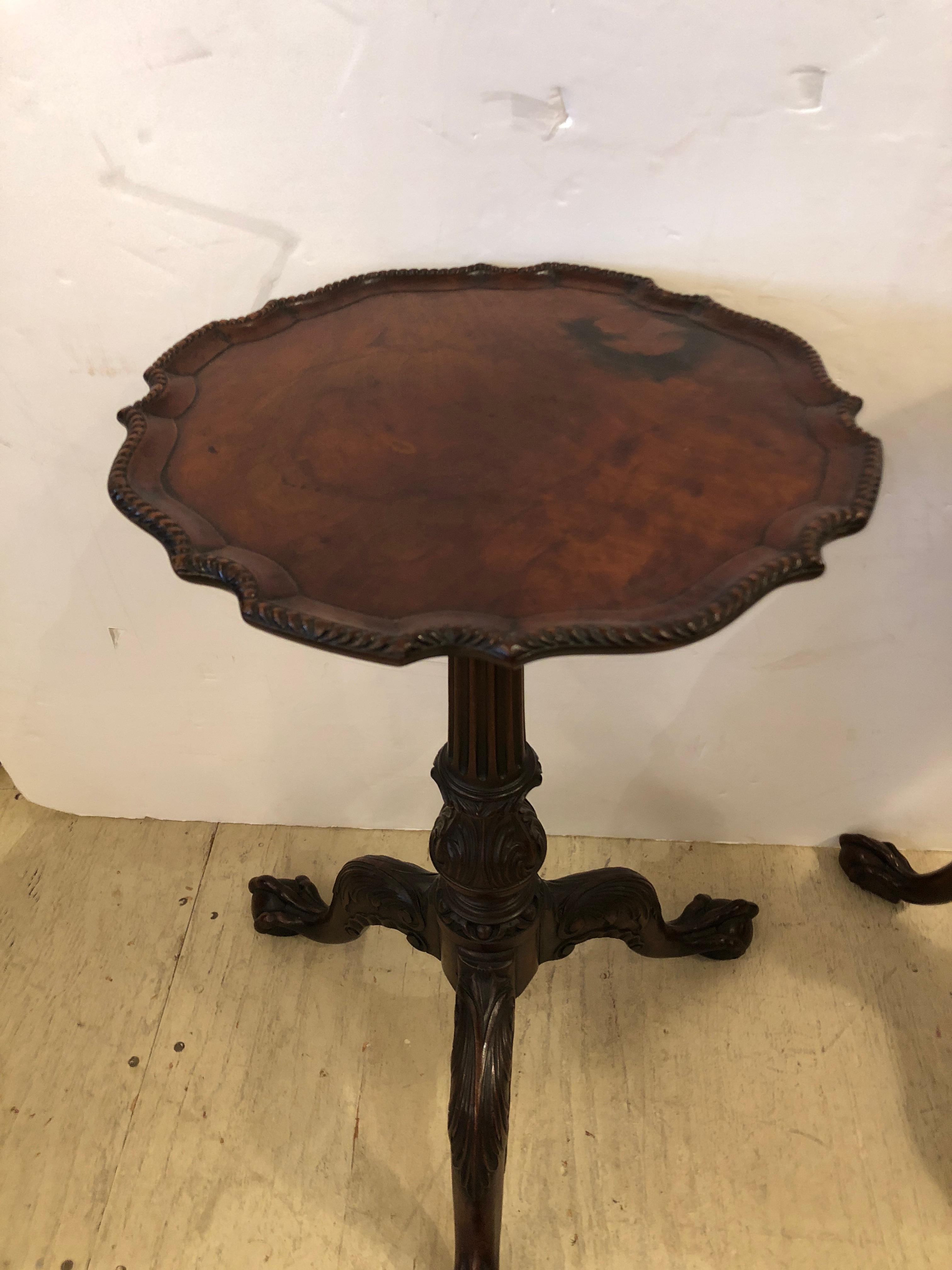 Lovely pair of elegant 19th century round small side or end tables, with slight variations with one table having a gadrooned edge, the other scalloped. Slightly different dimensions are also listed below. There are beautiful details such as ball and