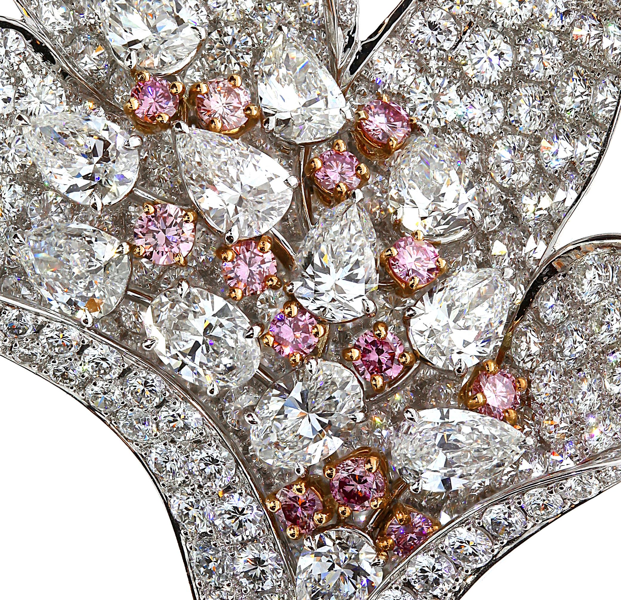 A guaranteed statement piece , this exquisite flower brooch by Chatila is set with 12 pink diamonds and 12 oval and pear shaped white diamonds. It is enhanced by 292 glistening white diamonds mounted in 18 carat white gold.


Details: 

-12 pink