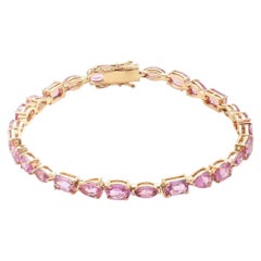 Tennisarmband aus 14-karätigem Gelbgold mit einem rosa Saphir von 12,69 Karat