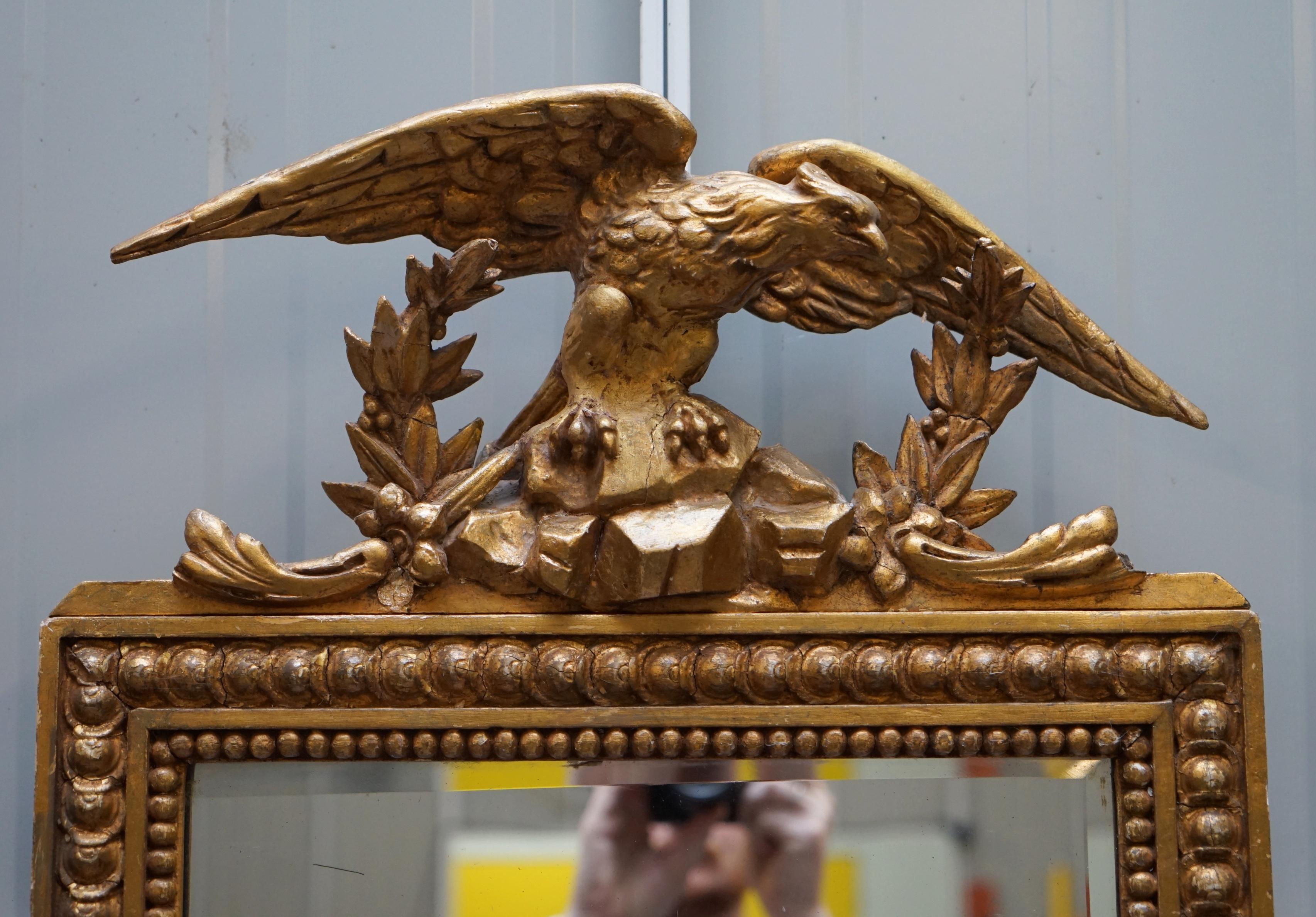We are delighted to offer this absolutely exquisite original Regency circa 1810-1820 hand carved gilded gesso wall mirror with oversized eagle top

This is a very decorative and beautifully carved Regency mirror. I has a gilded gesso finish which