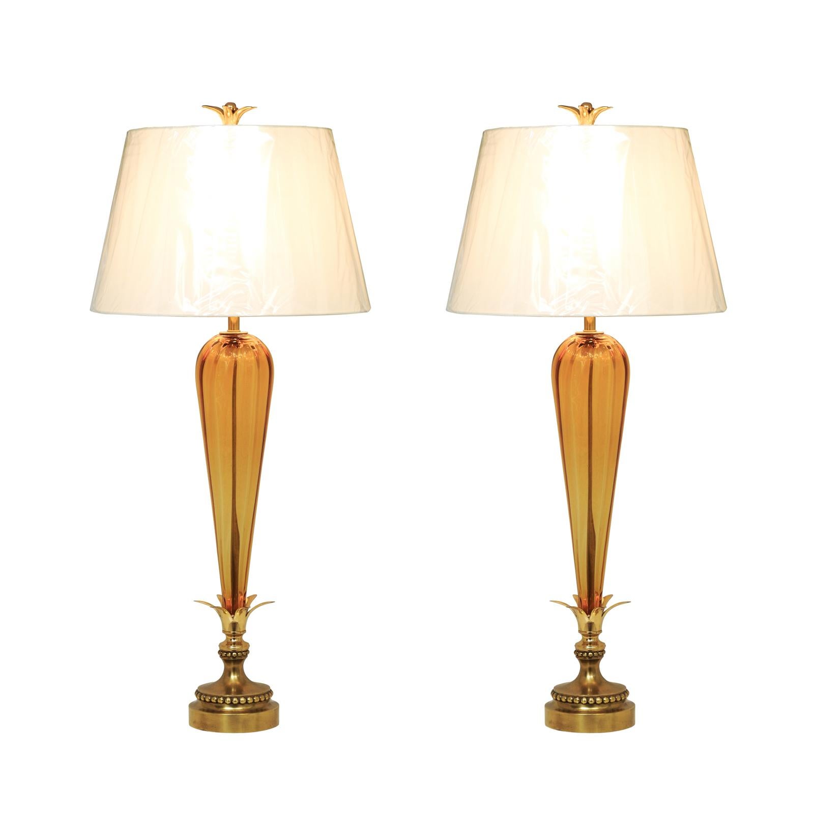 An elegant pair of large-scale Amber Tornado style blown Murano lamps, Italy, circa 1960. Stellar slender form, scale and color with stunning accents in brass. Meticulous professional restoration using components of the finest quality. Serious