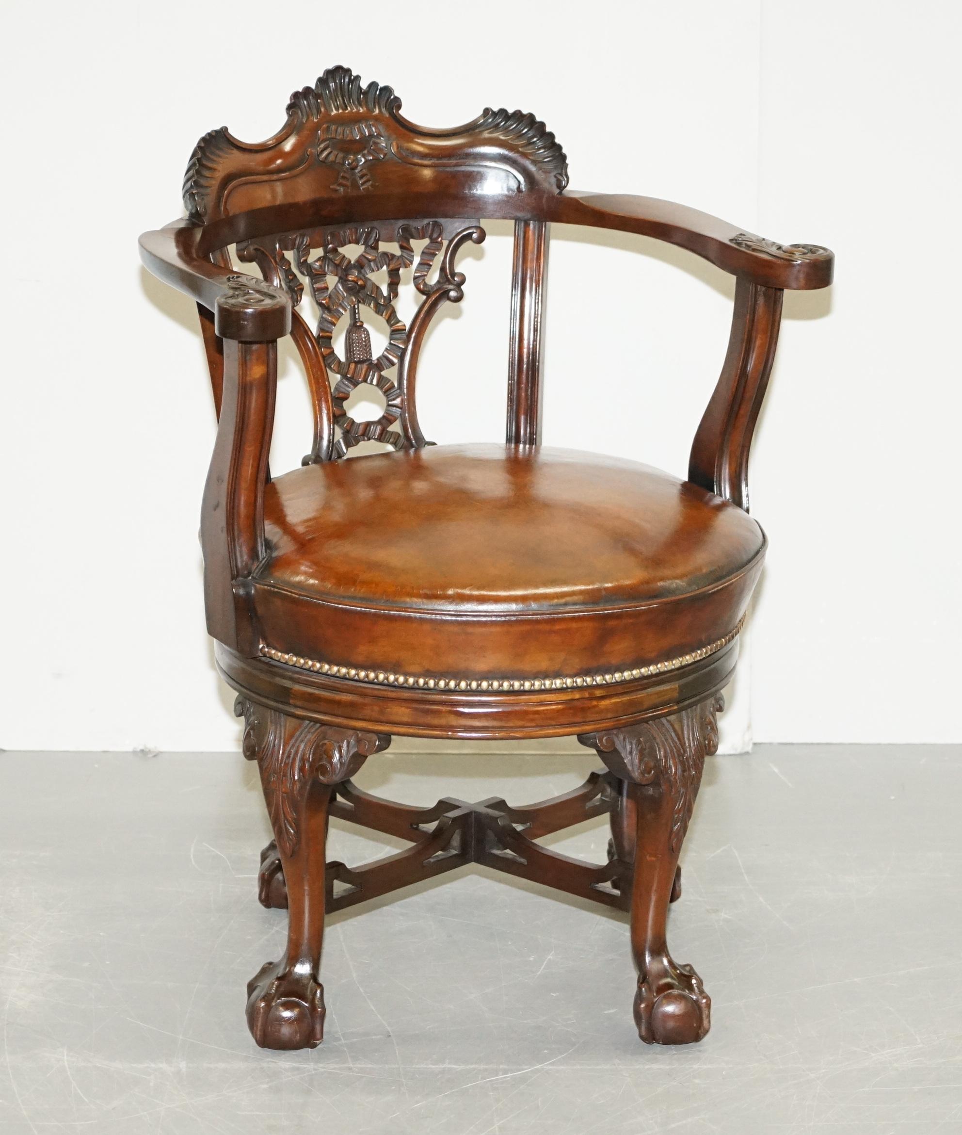 We are delighted to offer for sale this absolutely exquisite fully restored Thomas Chippendale style circa 1860 hand carved Victorian swivel armchair with oversized claw and ball feet and new hand dyed brown leather base

This chair is a real