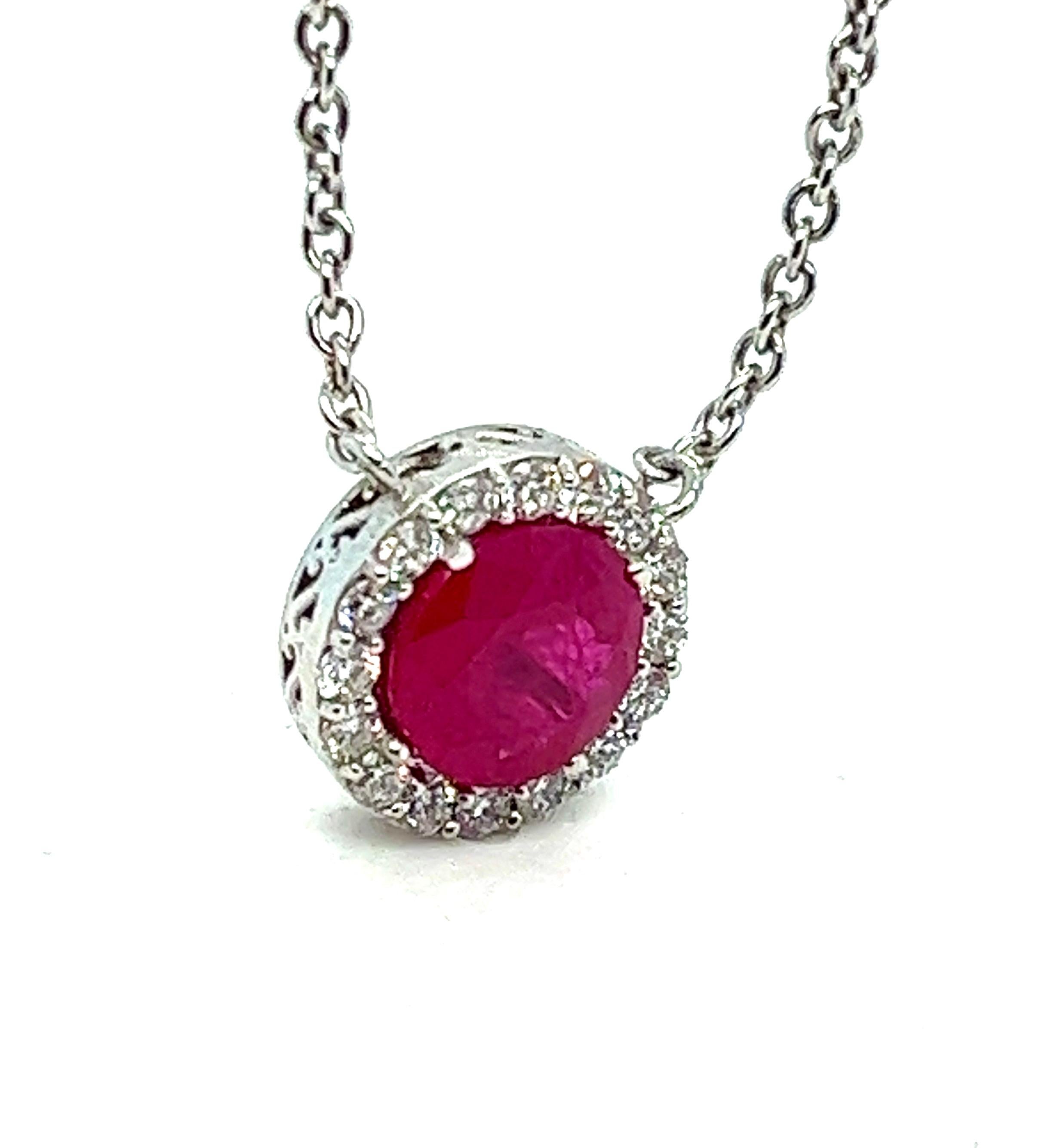 Offered here is an exquisite natural earth mined red ruby and pavé diamond pendant with a total diamond weight of 0.35 carat and showcasing a round 1.70 carats ruby.
Pendant is about 11 mm in diameter.
Crafted in solid 18 karat white gold, hanging