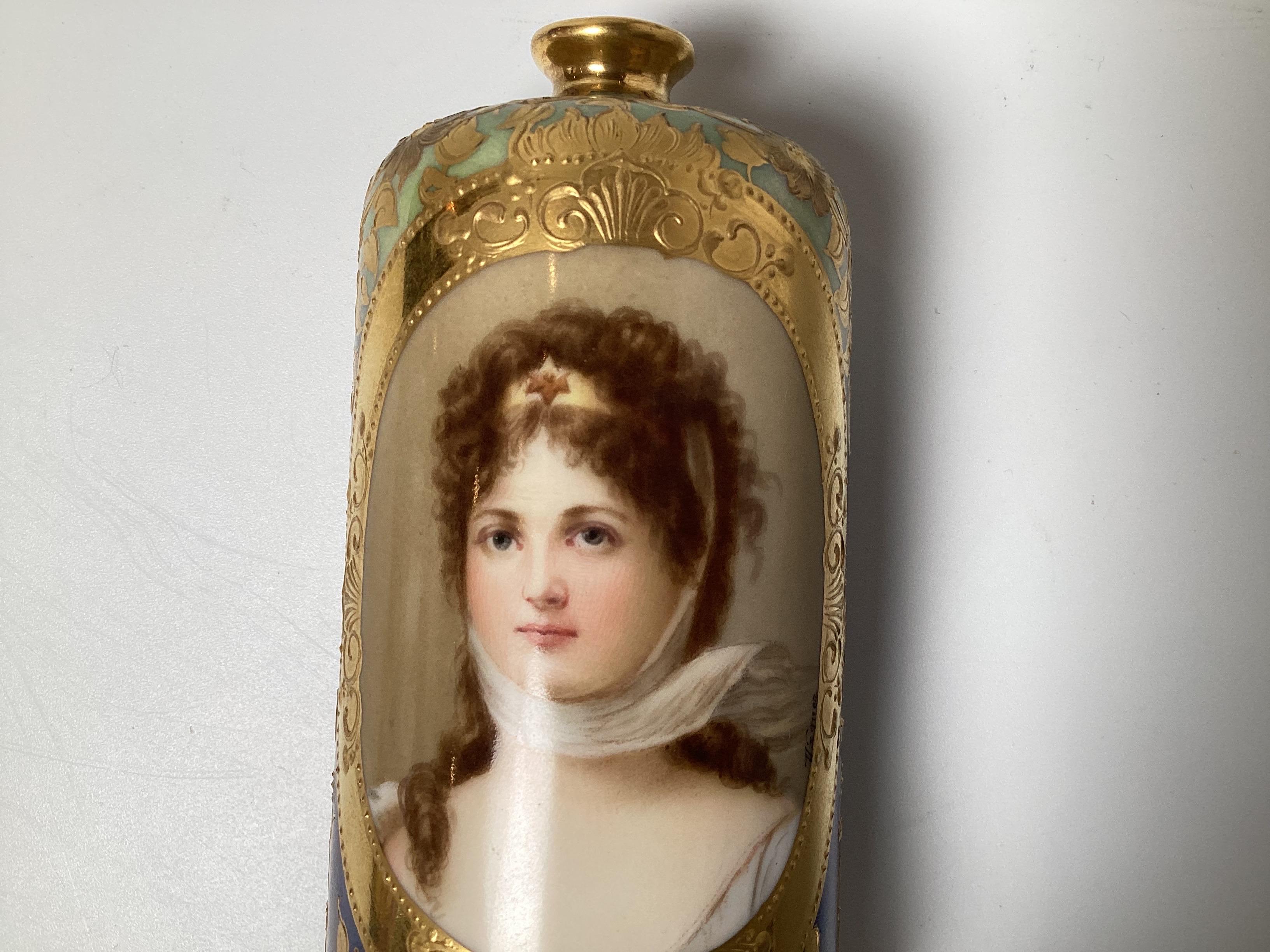 A diminutive and expertly painted cabinet vase with hand painted portrait of Queen Louise, signed Wagner.  The iridescent blue Background with raised hand gilt decoration with sunflowers, 5.25 inches tall, Austria, Circa 1900