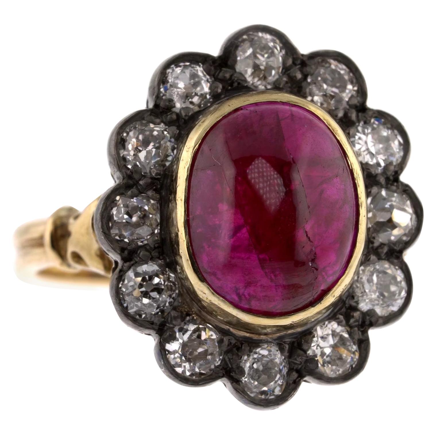 5.51 Carats Ruby Cabochon Ring with a Diamond Halo For Sale