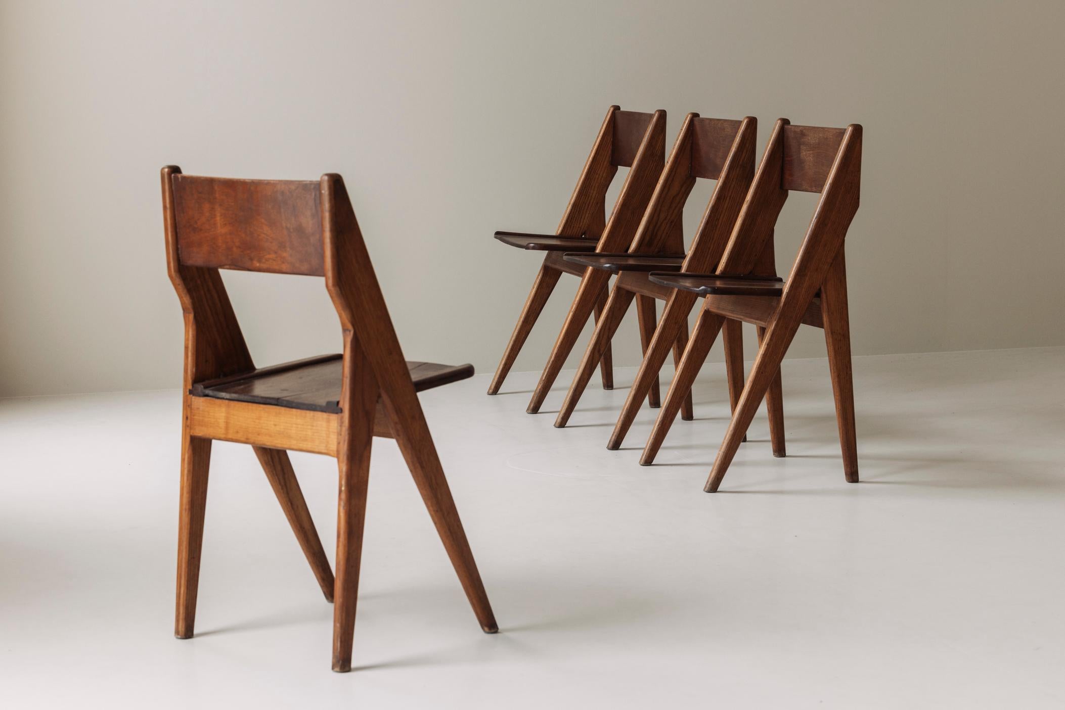 Exquisite set of four dining chairs sourced in France, dating from the 1950s. These ‘compass’ feet dining chairs are sculpted from solid wood and very well constructed. In the manner of Jean Prouvé. Presented in its original untouched condition with