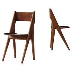 Exquisite set of four dining chairs in the manner of Jean Prouvé, France 1950s.