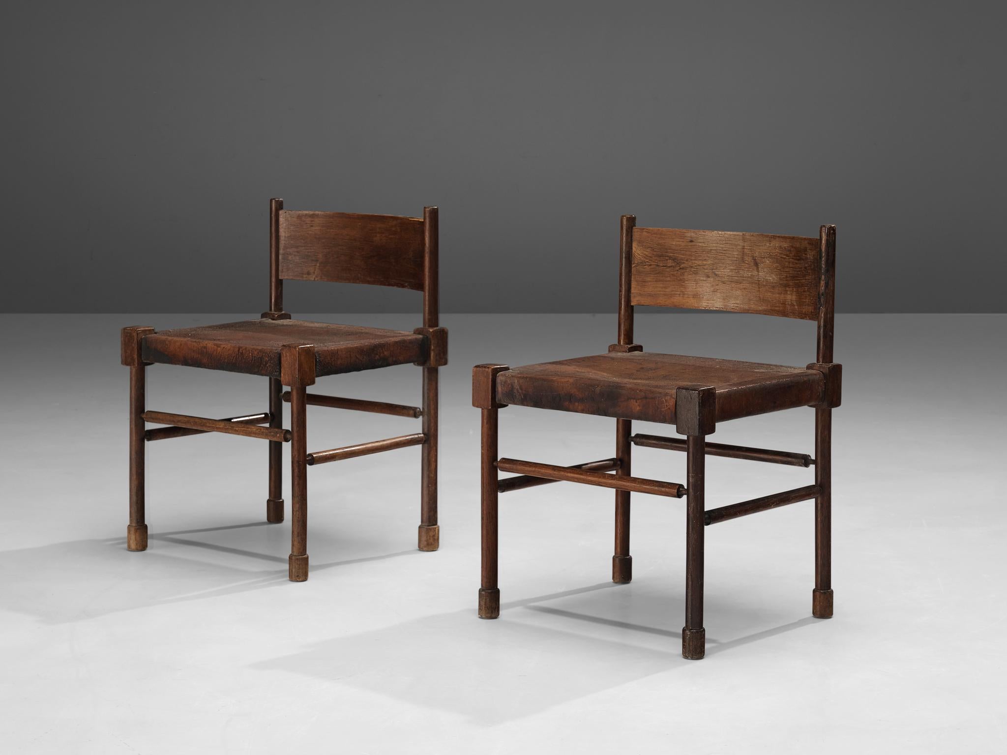 Side chairs, stained wood, patinated leather, Europe, 1940s

Rare side chairs with sculpted frame in stained wood and leather seats. What makes this design so unique is the way the designer played with proportions and shapes. The detailed carved