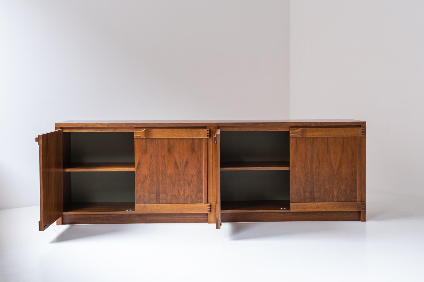 Exquisite sideboard by Franz Xaver Sproll, designed and manufactured in Switzerland around the 1960s. This rare credenza features four doors covering plenty of storage area with adjustable shelves inside. Great craftsmanship when you notice the