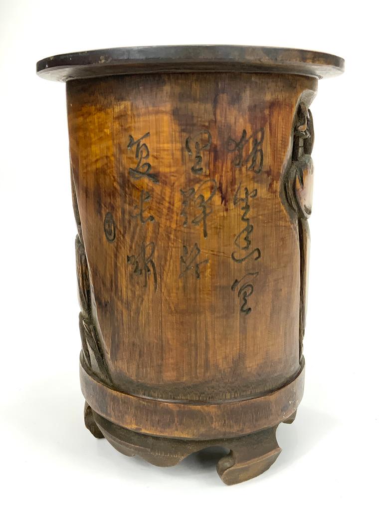 This beautifully carved bamboo root brush pot is in excellent condition. No chips on the carving or any of the wood. It has a smooth finish with no rough areas.

The scene on one side of bamboo pot has four separate figures in a village setting. One