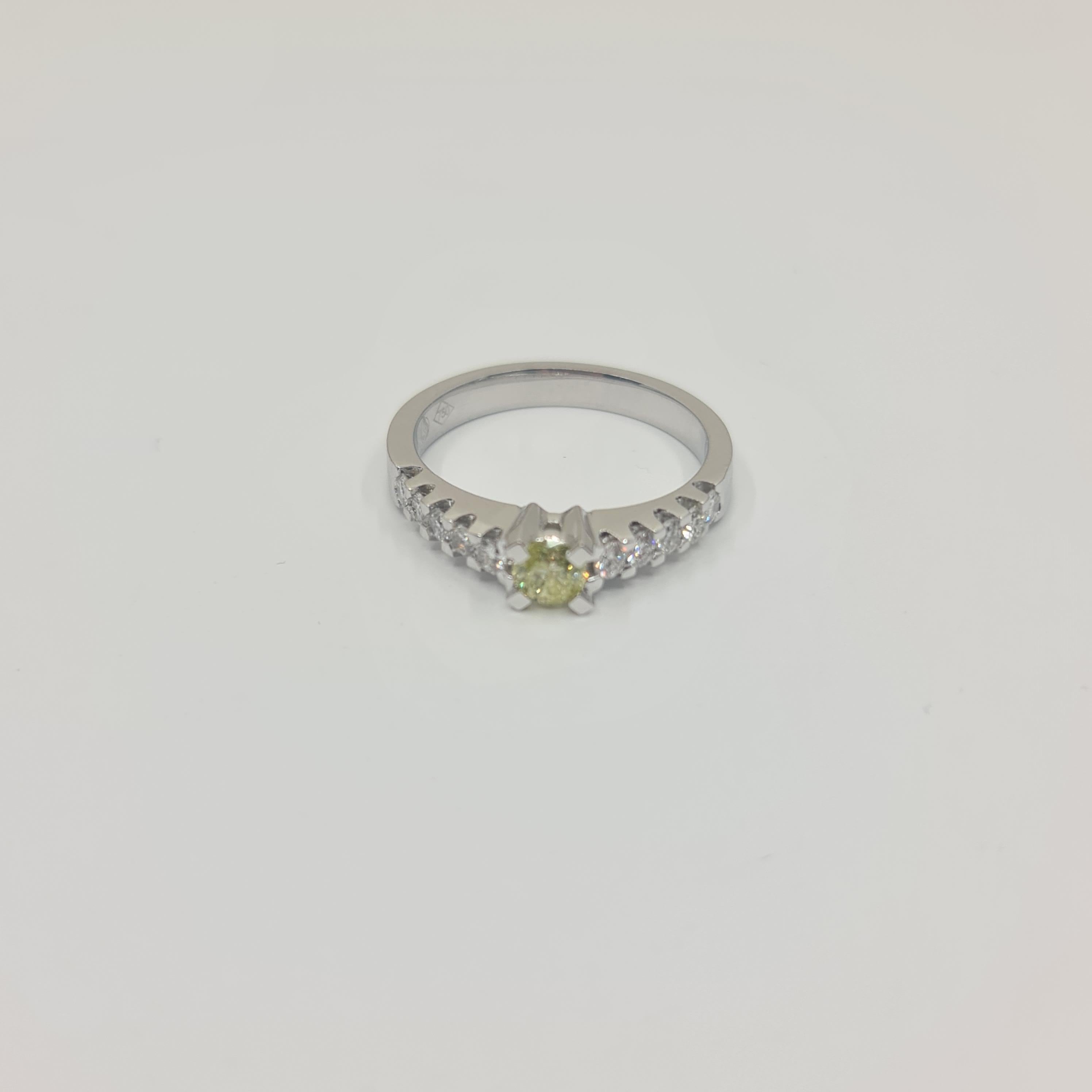 Exquisite Solitaire Diamond Ring 0.28 Carat Fancy Green Brilliant 

Total Diamonds 0.63 Carat(Sidestones: 0.35 Carat).

Unique, 18k Whitegold Ring with Fancy Green(Treated Color) Center Diamond in Brilliant Cut and Diamond Side Stones 0.35 Carat