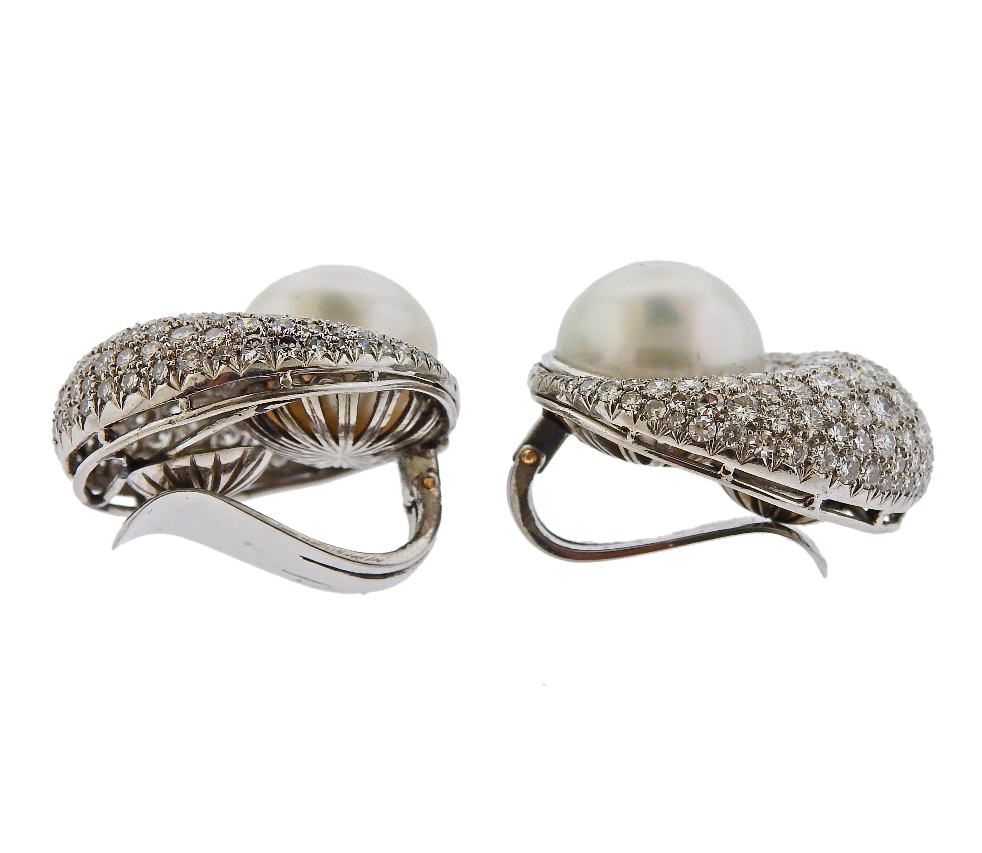 Pair of large platinum earrings, featuring 13.5mm South Sea pearls, surrounded with a total of approx. 6 carats in diamonds. Earrings are 25nn in diameter. Tested platinum, weigh 29 grams.

SKU#E-02687