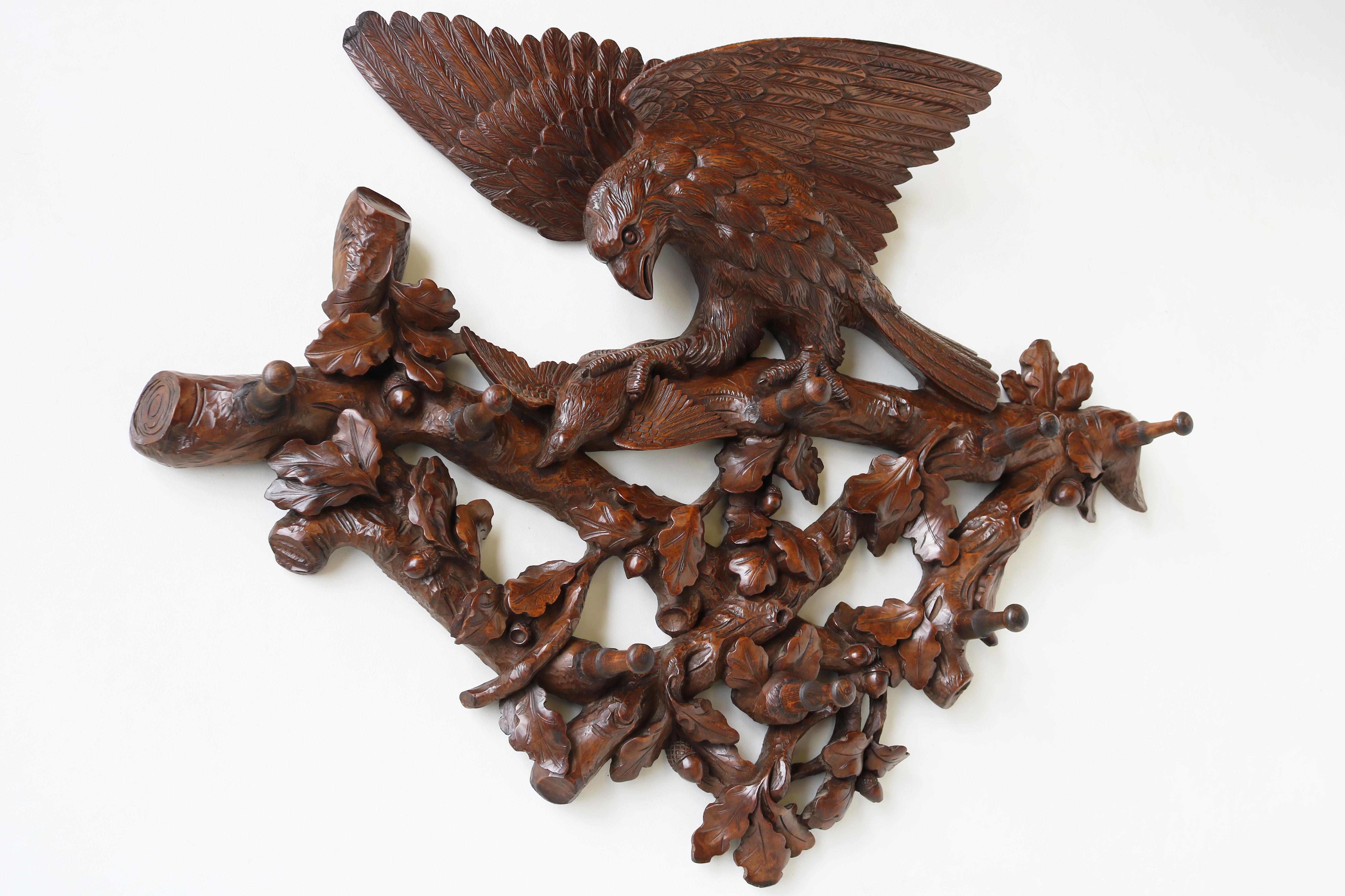 Exquisite & most impressive! This 19th century Swiss Black Forest eagle coat rack from carved walnut. 
Very large, highly detailed model with 8 hooks for plenty of coats. 
The coat rack shows a scene of an eagle holding down its prey. Richly