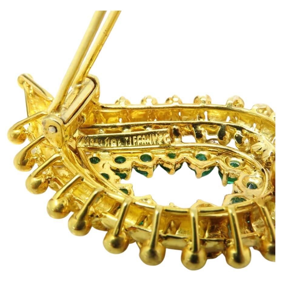 Discover the timeless elegance of this Tiffany & Co. exquisite Tiffany & Co. 18k Gold Emerald and Diamond Brooch
Discover timeless sophistication with this stunning Tiffany & Co. emerald and diamond brooch, a perfect accessory to elevate any