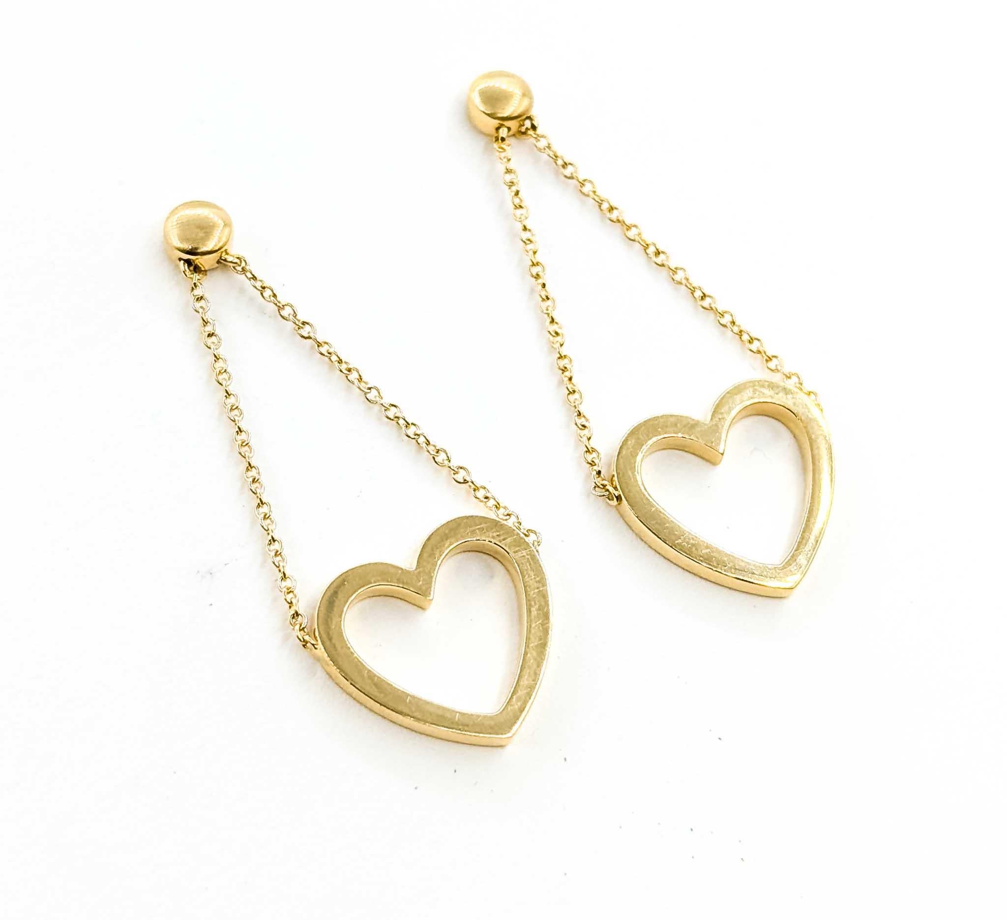 Exquisite Tiffany & Co. Dangle Open Heart Earrings in 18k Gold

Introducing the exquisite Tiffany & Co. Dangle Open Heart Earrings, a radiant embodiment of luxury and elegance. Crafted meticulously in 18k yellow gold, these designer earrings are a