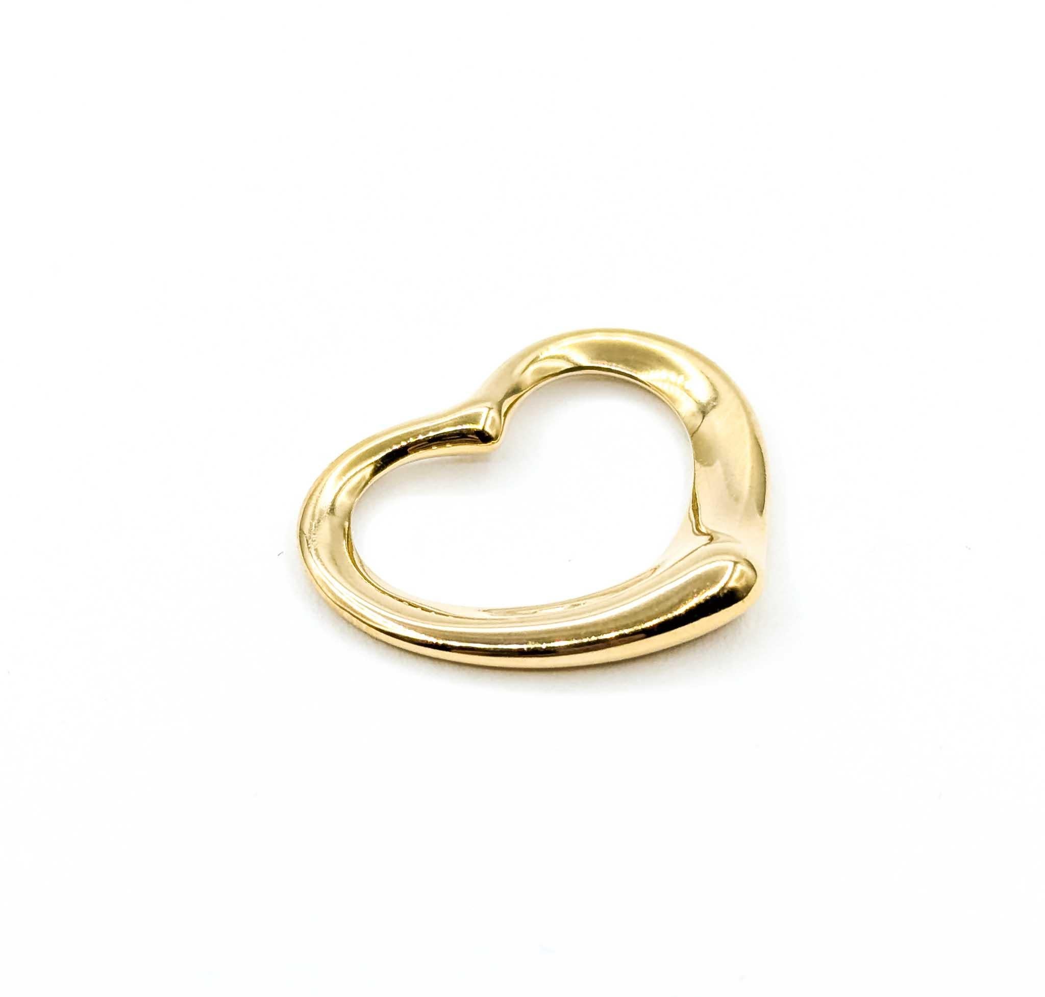 Introducing this beautiful pendant crafted in 18k yellow gold, the Tiffany Elsa Peretti Heart Pendant is a splendid representation of timeless elegance. The pendant is designed with a captivating heart motif that showcases the artistry and