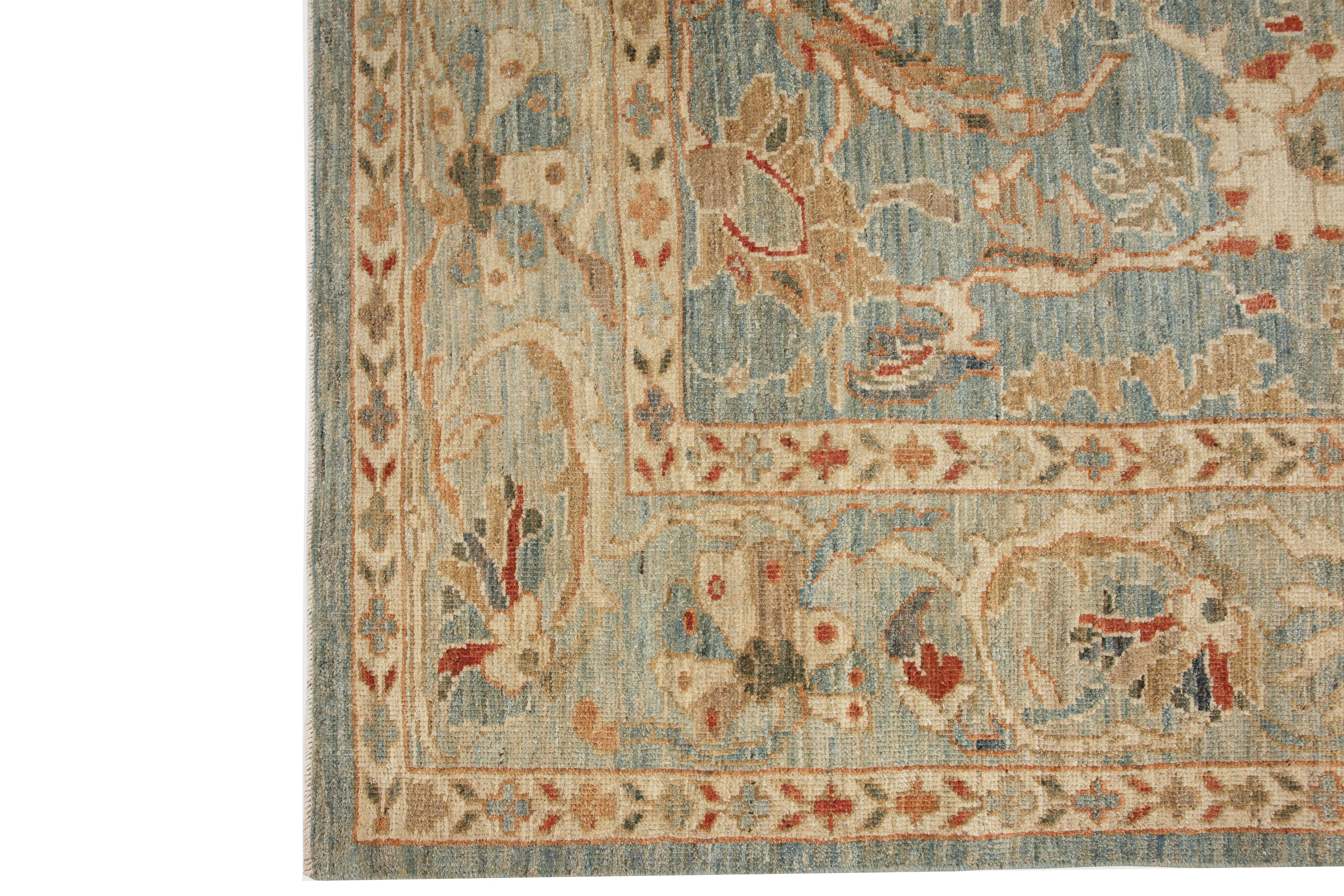 Introducing our exquisite handmade Sultanabad rug from Turkey, featuring a stunning light blue background and a distinct border that adds a touch of elegance to any room. The traditional design boasts a beautiful color palette of blue, orange, red,