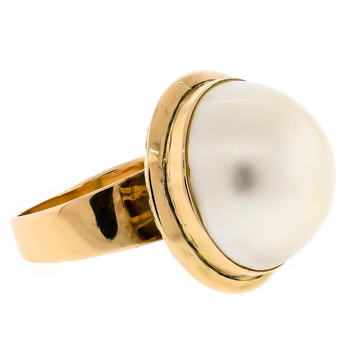 This fantastic suite contains a pair of luxurious large mabé pearl earrings and one large mabé pearl ring all crafted in 14 karat gold. The exquisite lustrous mabé pearl earrings backed with posts and omega clips for comfort and safety molded out of
