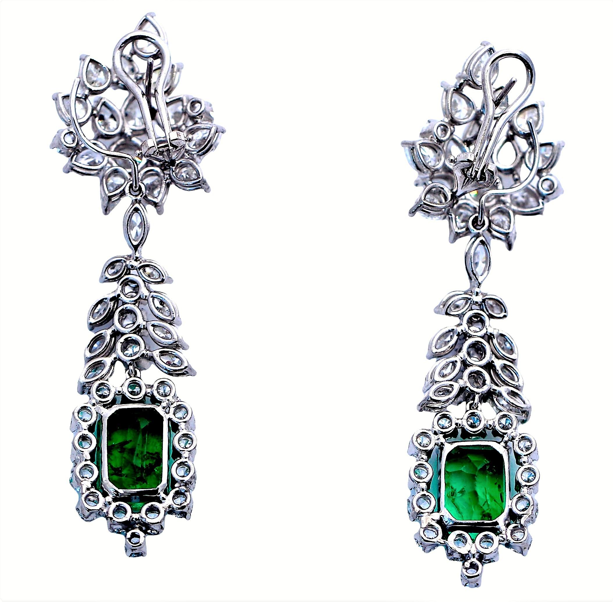 This outstanding pair of handmade, platinum, Mid-20th Century cocktail earrings is set with two Colombian emeralds having a total weight of 8.80ct. The pair of emeralds are vibrant, brilliant, and are exemplary of fine Colombian color. It is