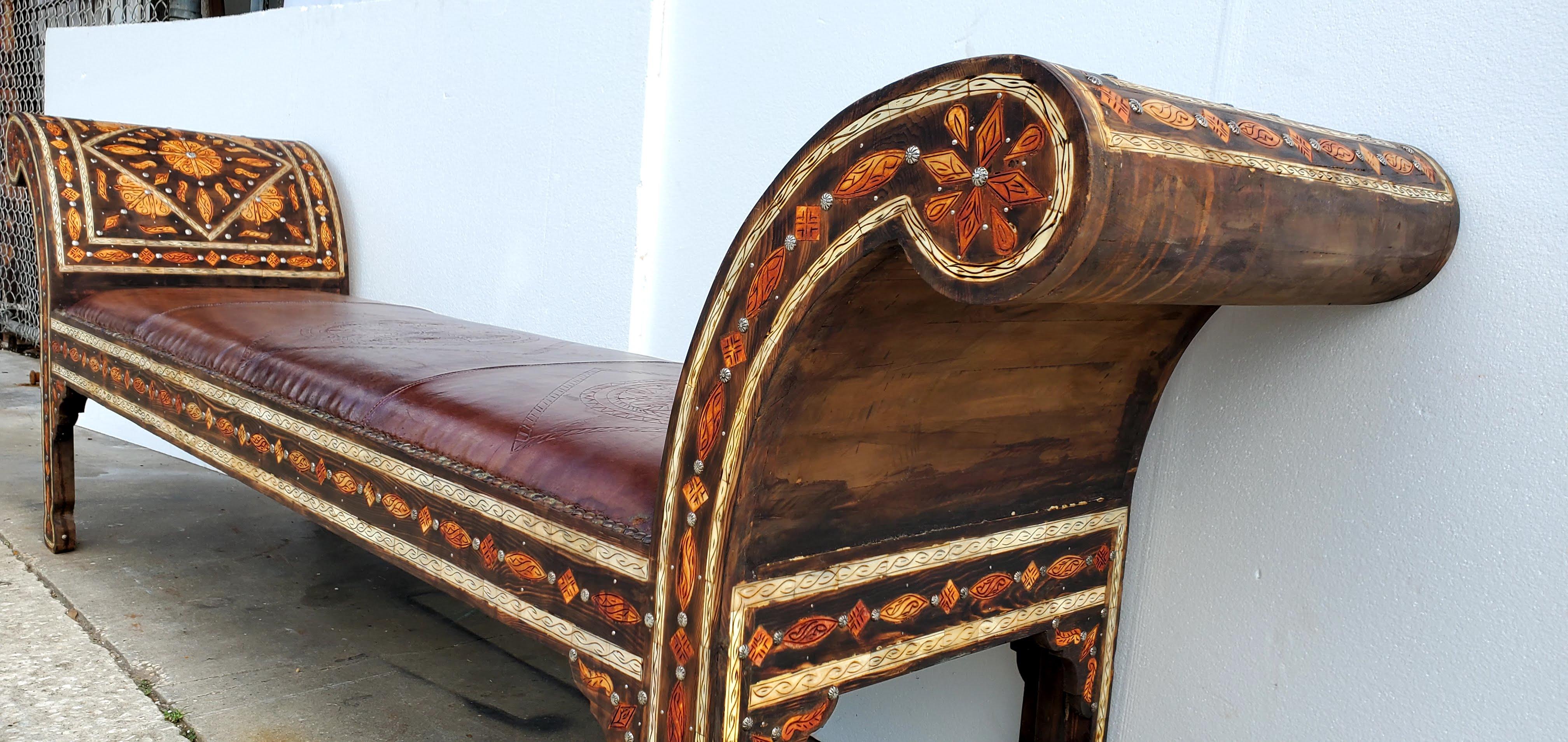 
Exquisite vintage royal inlaid camel bone bench reupholstered with hand tanned dark moroccan leather. Indigenous cedar inlaid with henna stained camel bone & all hand carved handmade by master artisans.A stunning piece of furniture for your living
