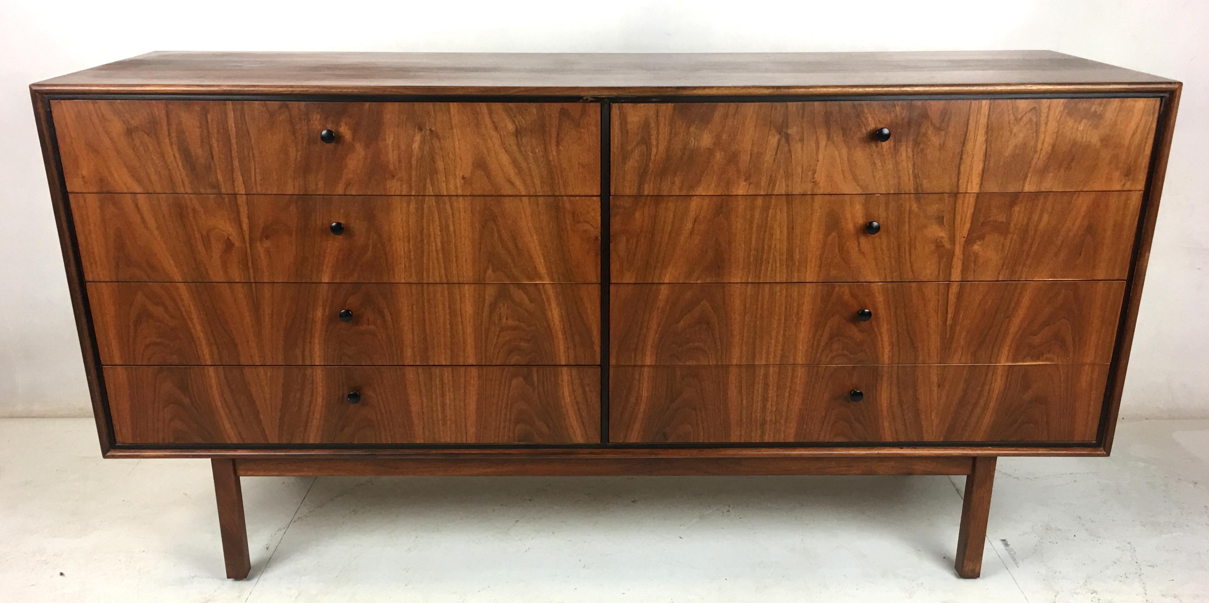 Handsome eight-drawer dresser of vibrant matched-grain walnut with ebony trim by Jack Cartwright for Founders. This small and coveted collection of case goods is quite rare and desirable, especially in such beautiful original condition. Legs have