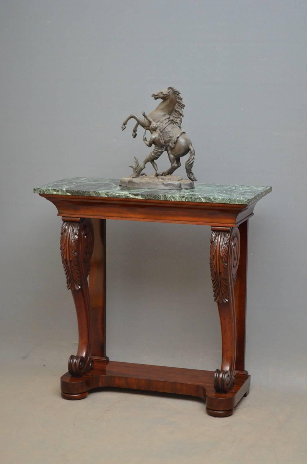 Sn4265, fine William IV hall table in mahogany, having stunning veined green marble top above concave frieze raised on beautifully carved legs terminating in shaped base and bun feet. This antique mahogany hall table retains its original finish,