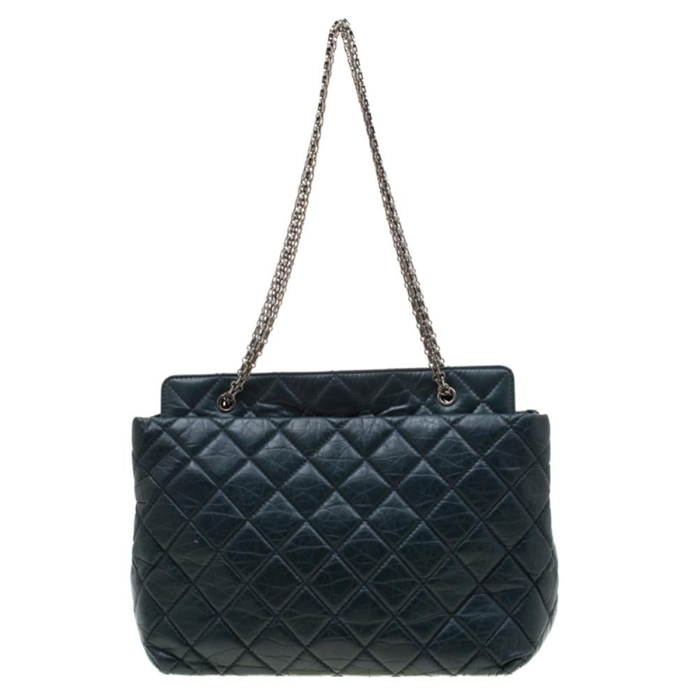 Exquisitely crafted from aged leather, this Reissue tote from Chanel bears their label on the fabric interior and a stylish mademoiselle lock on top. It is covered in the signature quilts and the piece is complete black-tone hardware and dual chain