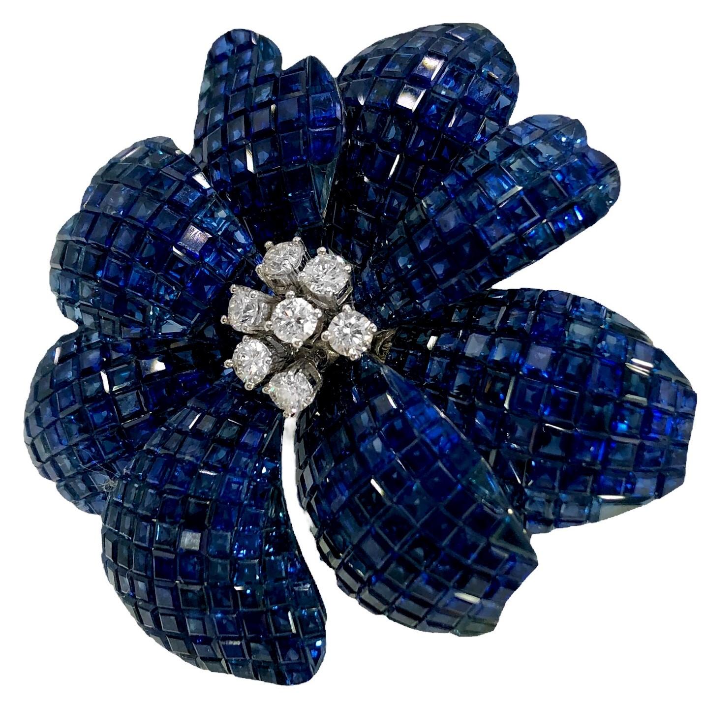 This opulent contemporary 18K white gold flower brooch* is absolutely life like in appearance and is prong set at the center with seven brilliant cut diamonds with a total approximate weight of .75CT of overall G color and VS1 clarity. Surrounding