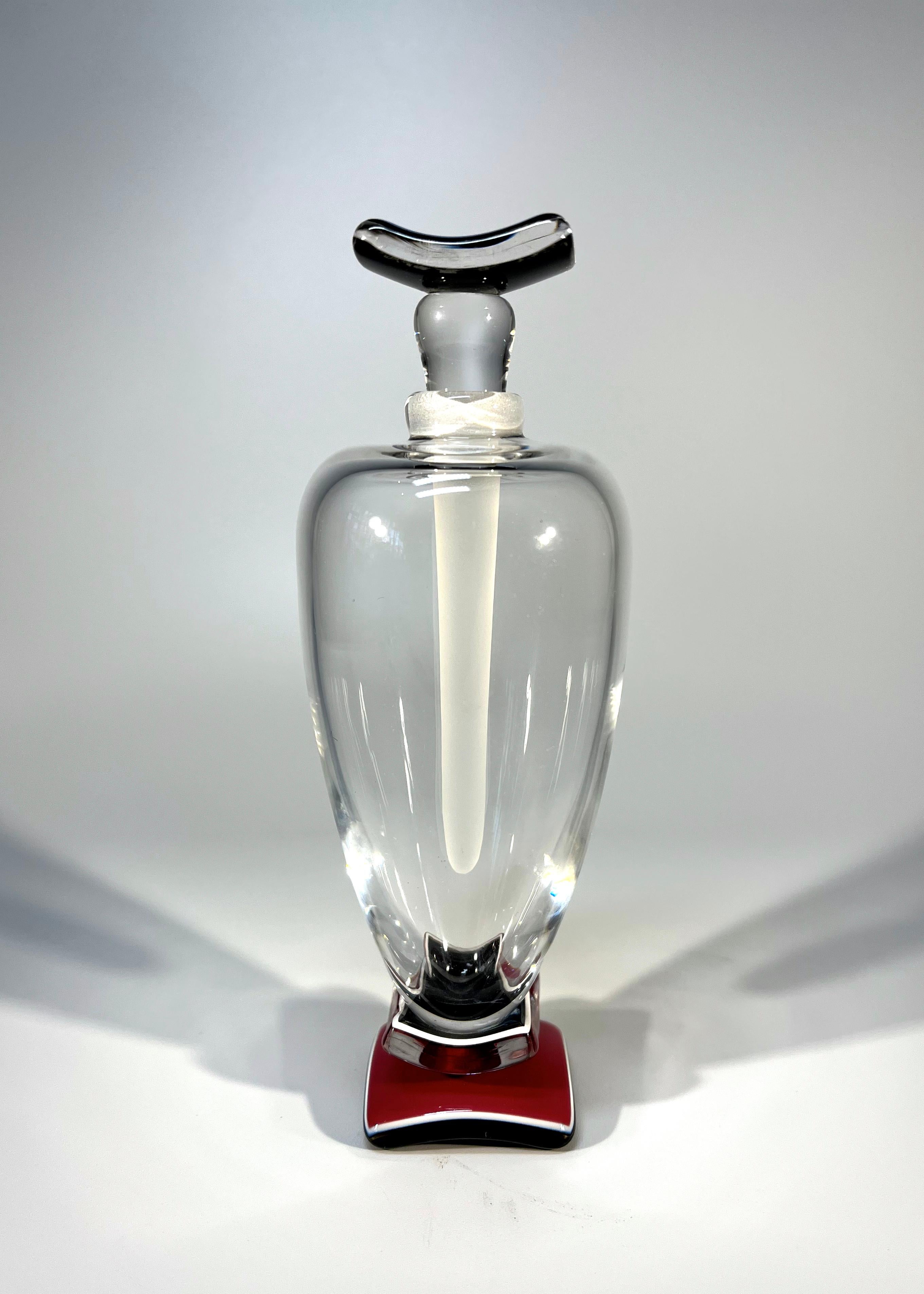 An elegantly tall perfume bottle of clear, deep rose pink and black crystal
Especial elongated frosted crystal stopper
Created by superbly talented glass artist Anthony Wassell, England
Signature etched to base
Circa 1990-2003
Height with stopper 6