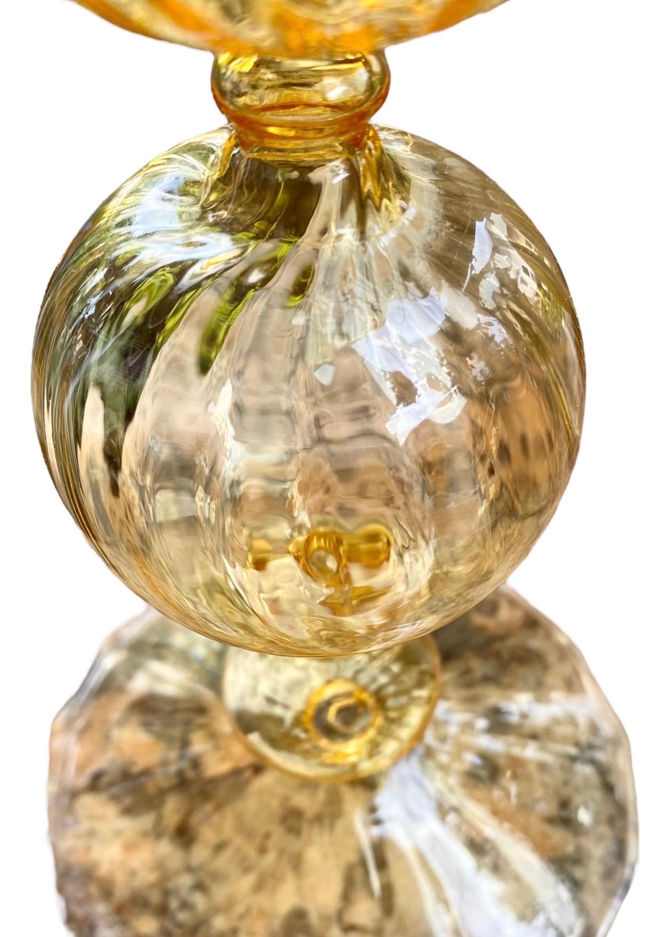 An exquisite vintage swirled glass candlestick, this is Venetian and is hand blown in an exceptionally thin yellow glass. The candlestick measures 10.5” tall by 4” wide at the base and dates to the second half of last century, it is in excellent