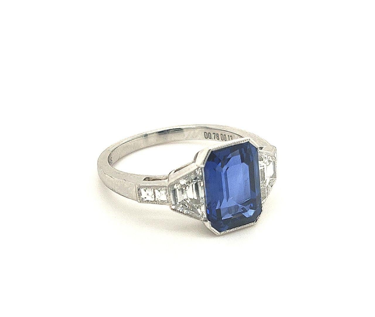 Certified sapphire center weighing 3.15 carats with two trapezoid diamonds weighing 0.78 carats and two square diamonds weighing 0.13 carats.