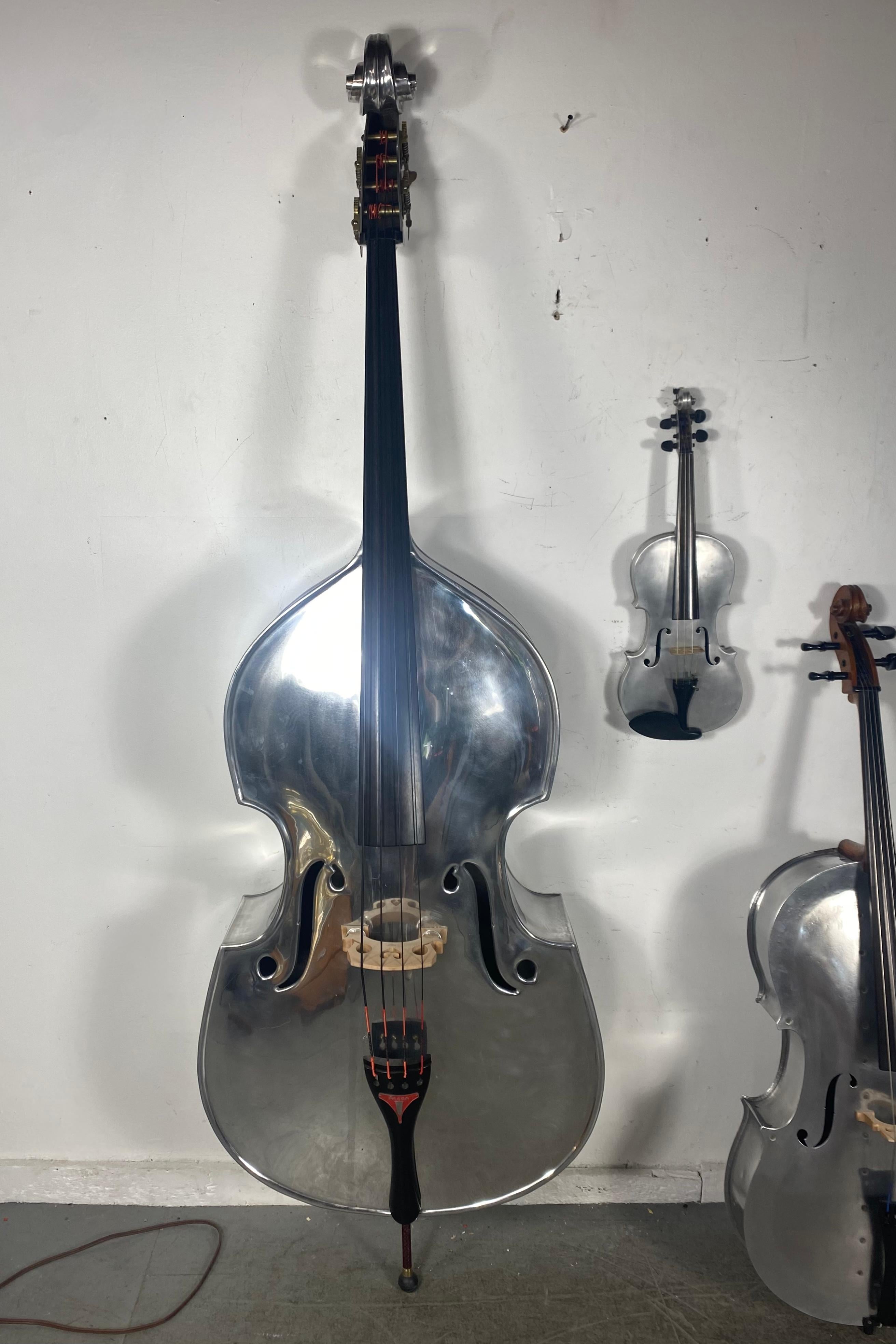 This set took me over 20 years to procure.....Dont miss this opportunity!!!!Being offered extremely rare collection of aluminum string instruments,,string bass, ,cello,,and violin....... circa 1930s, all 3 instruments originaly wood grain painted,