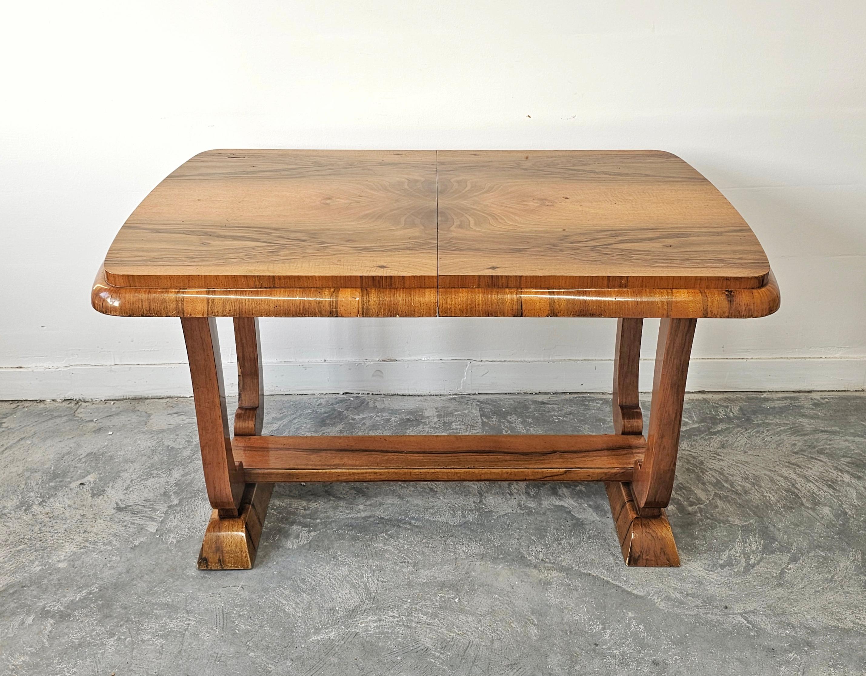 In this listing you will find a gorgeous Extendable Art Deco Dining Table. It features a beautiful and rich walnut veneer top and harp-shaped legs. It extends from a table for 6 to a table for 8 people,, going from 127cm to 173cm. Made in Austria in