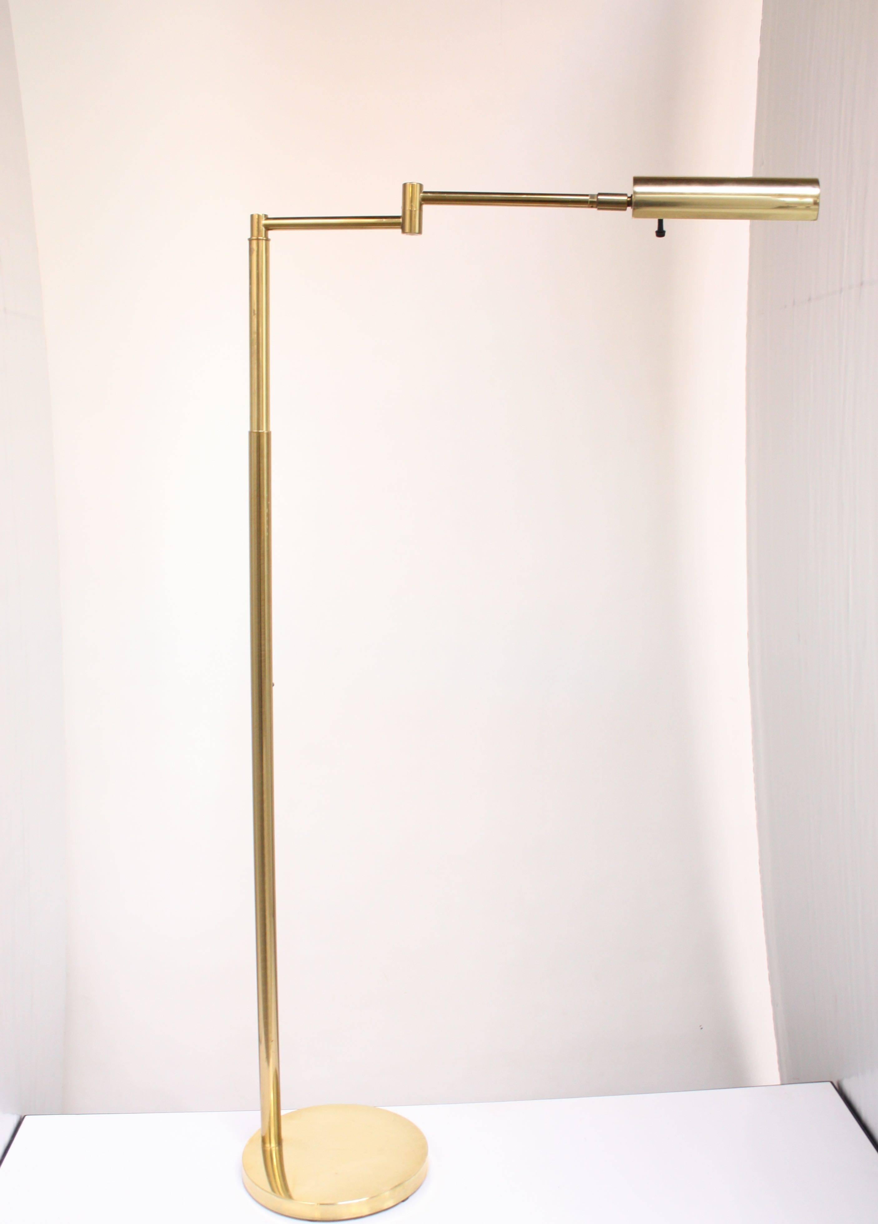 1950s brass floor Lamp by Koch & Lowy composed of a telescoping / swiveling arm and a full 360 degree adjustable shade. Additionally the height can be lowered by 10