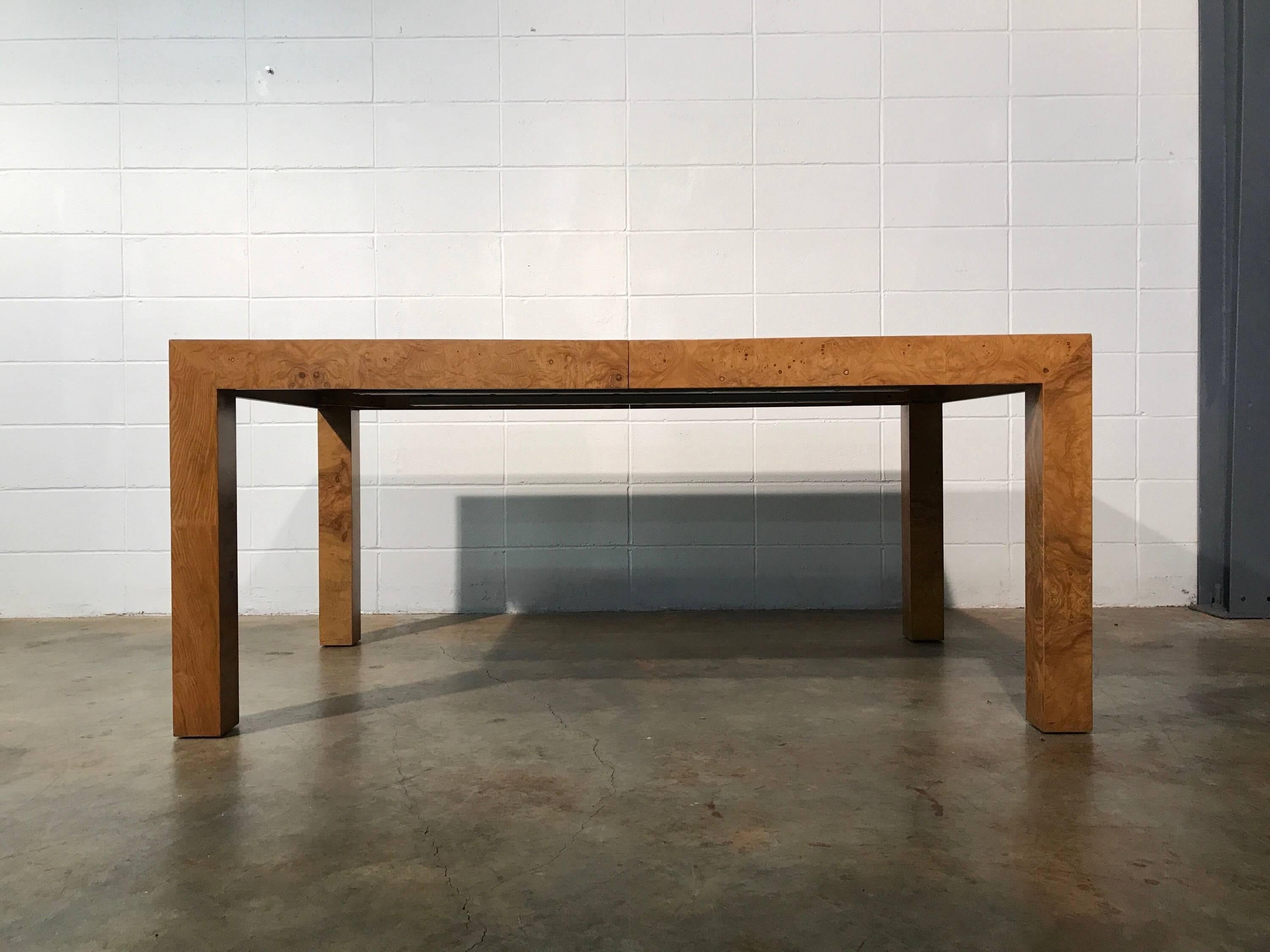 Mid-Century Modern extendable burl wood dining table designed by Milo Baughman for Thayer Coggin.
This table shows amazing graining as expected from a Baughman piece. Includes two large leaves for an extra 44