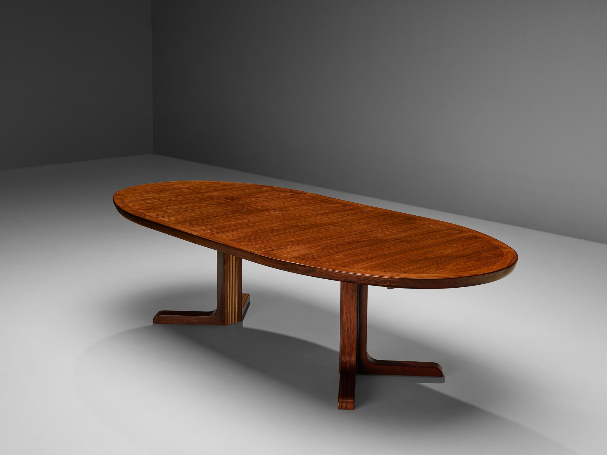 Extendable dining table, teak, Denmark, 1950s

With two extra leaves this table can be extended form a small, round size to a large, oval format. The table top is veneered in the matter of parallel lines. With the natural teak grains the top gets