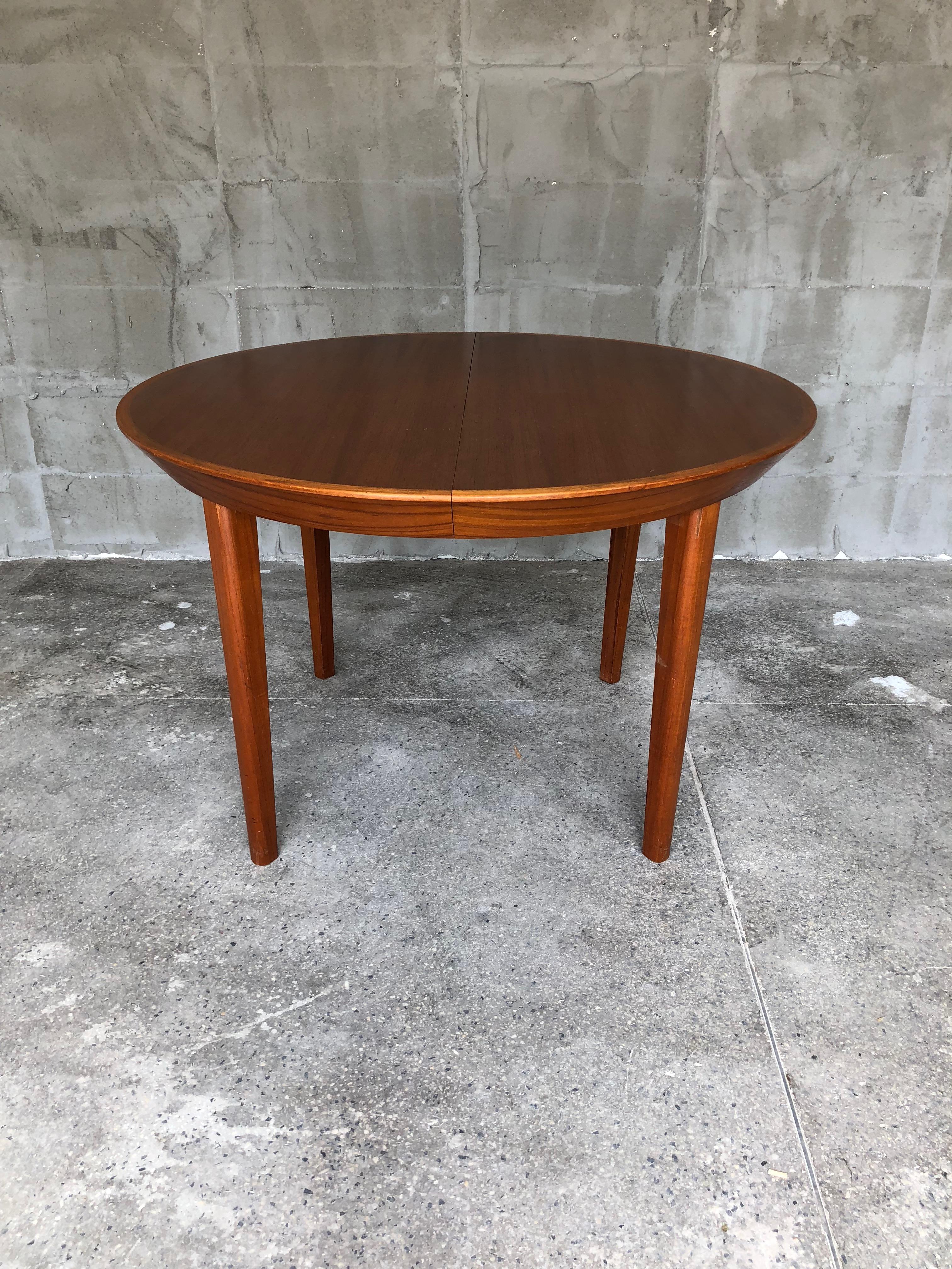 Charming danish extendabe dining table created by the danish designer Ole Hald in the 1960s. The teak table has two extentions that stretch it up to 210 cm. 
The table is in very good condition but has some minor traces of use. There are some small